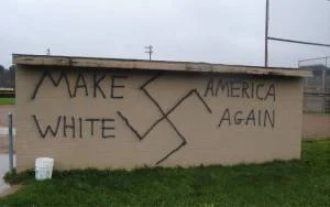 Graffiti on the side of a softball dugout at a college campus in Wellsville, New York (November 2016).