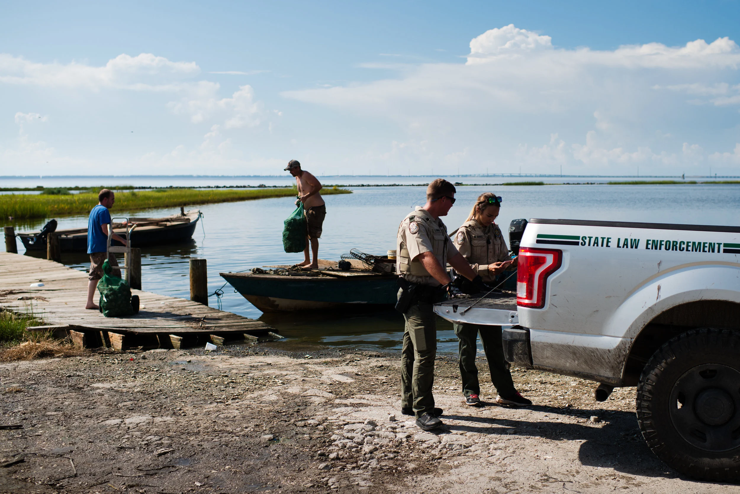 Florida State Law Enforcement agents inspect oyster boats arriving at a seafood wholesaler where they sell their catch. Due to the sharp decline in the oyster population of the bay, the state and local authorities have placed strong restrictions on oyster production. During summer months, oystermen can only work on the water from sunrise to 11am. They are only allowed a maximum (which they never reach) of two 50lbs bags per person and all oysters much be at least 3 inches. Cheating is common and fines are steep, $550 if caught.