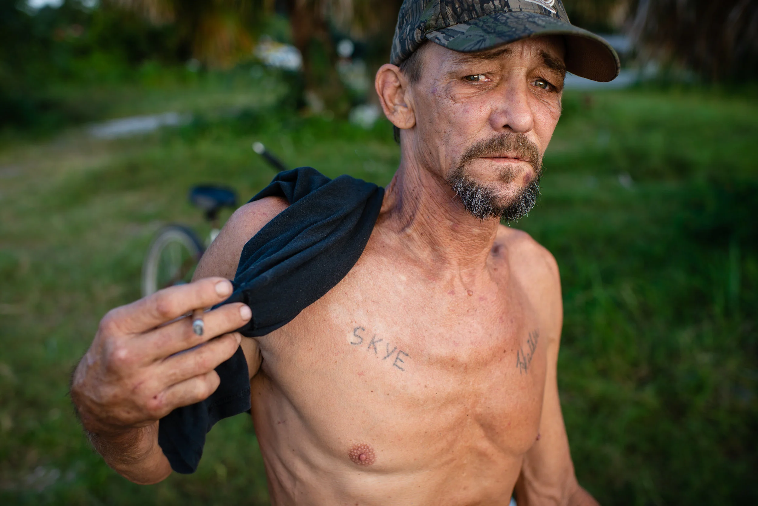 On his chest Fred Wilsey, 53, has two tattoos, one for his daughter Skye and the other for his girlfriend Heather Petty. Fred and Heather have been homeless since 04 July, 2018. Fred has spent most his life, 38 years, living off the what the Apalachicola bay provides, Heather, who came to the area 10 years ago to care for her dying father joined Fred on the boat. Five years ago, because of smaller hauls, they quit harvesting oysters full-time and began cleaning rental properties on nearby Saint George Island, a popular tourist destination. When they began cleaning homes they would make combined $1500 a week, now $500 if they are lucky enough to find work. “People come here because of oysters,” said Fred. “Now that there is a depletion of oysters, fewer people are coming here.” With little work and loss of their savings, Fred and Heather now sleep on the docks and have returned to fishing, not always legally, to survive. “The water is all we have left,” Heather said. “You have to be a felon to eat around here. That is what they are turning us it into.”