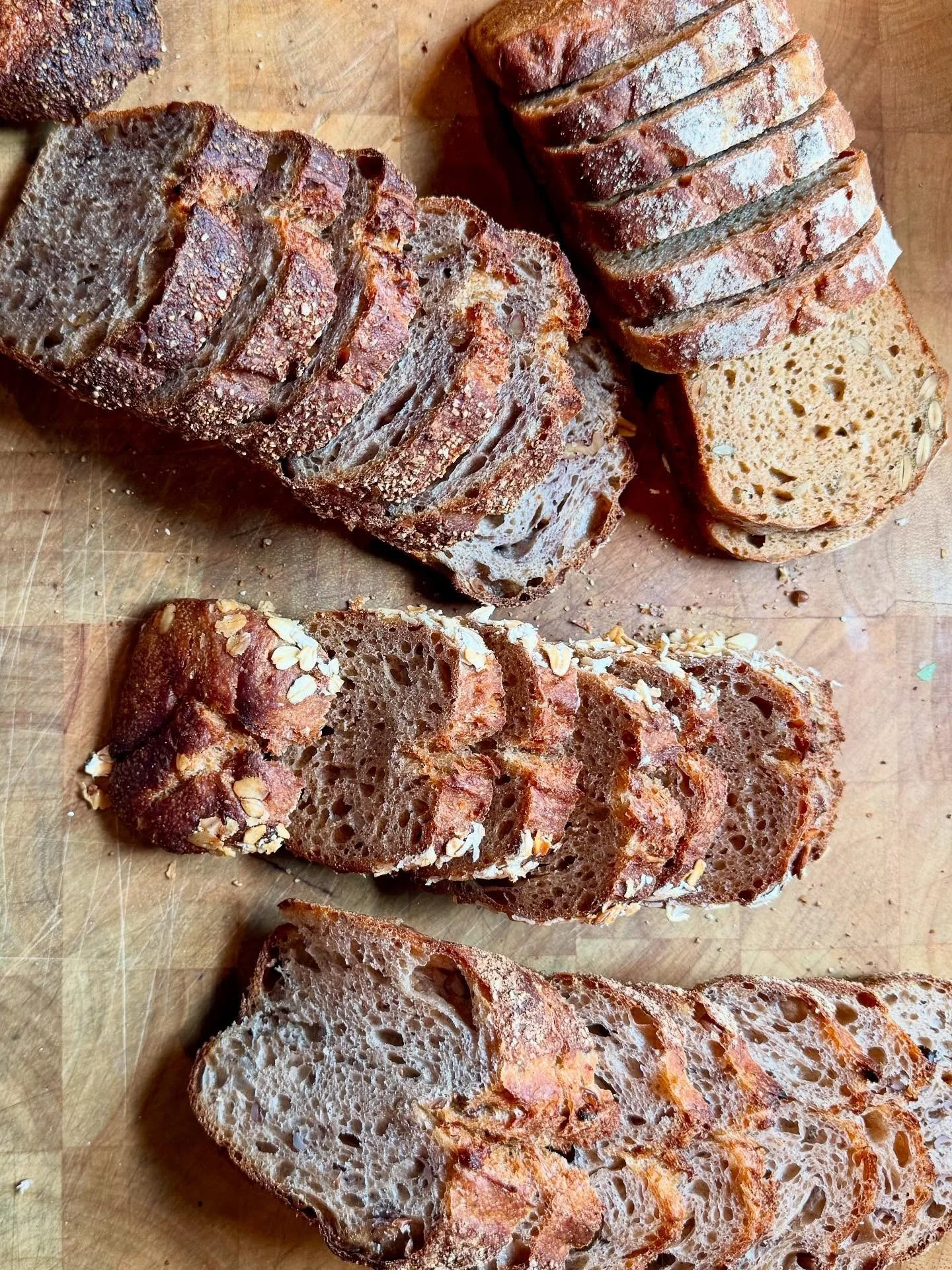 Slicing minis for the freezer. Tomorrow we will be at the PSU Market and here&rsquo;s the bread menu: 🌾Purple Karma Barley, 🌾Einkorn Pepita, 🌾Walnut Red Fife, 🌾Whole Wheat Oat Porridge, 🌾Seeded Buckwheat with Fennel and Plum. See you there!
