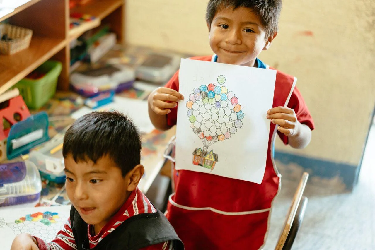 Kid showing his drawing Ninos de Guatemala.jpg