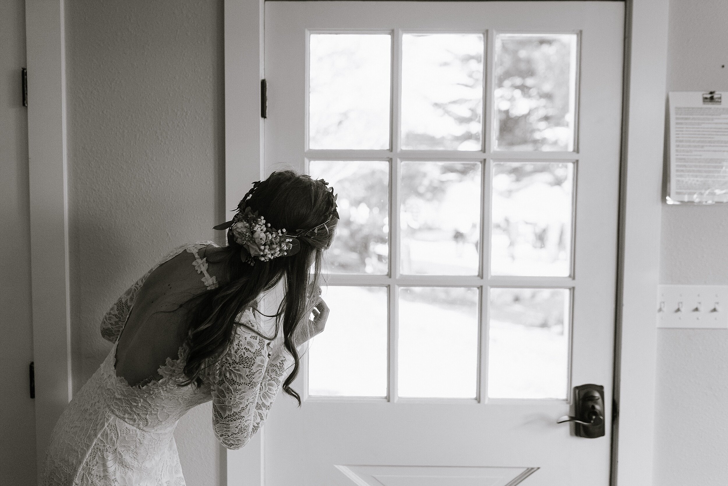 bride peeking at guests arriving to stemple creek ranch