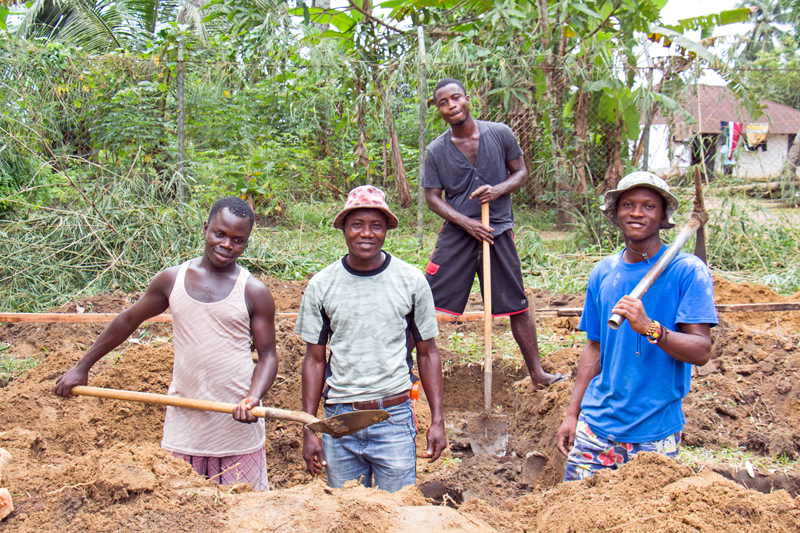 Students working on the bathroom foundation.