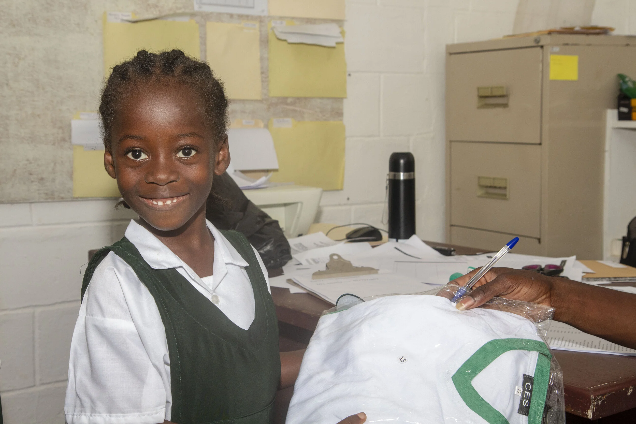 One young student is happy to receive her brand-new P.E. uniform.