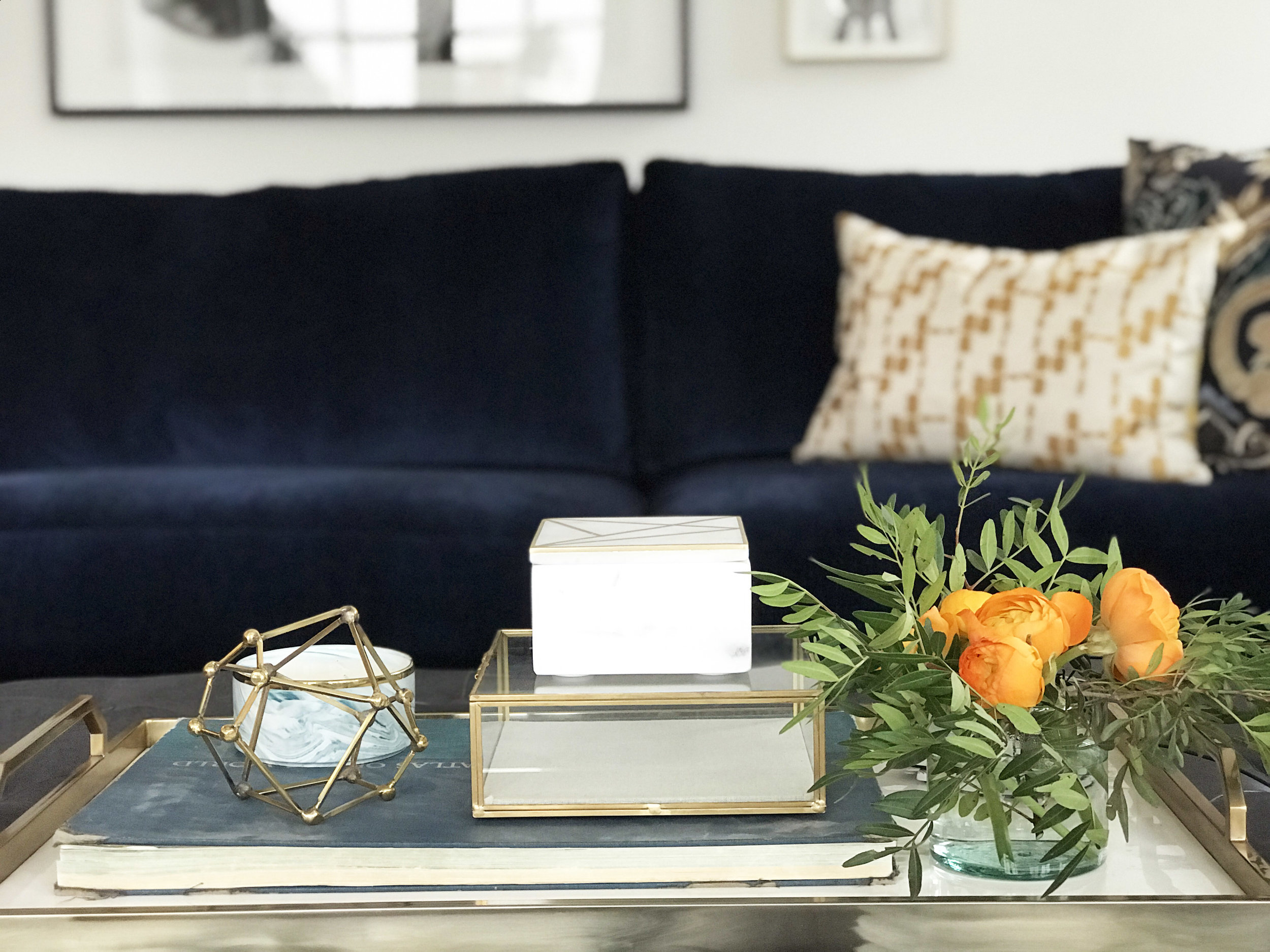 Family focused living space with wood beam ceiling detail and navy chenille sectional. Interior Design by Nyla Free Designs, Build by Veranda Estate Homes