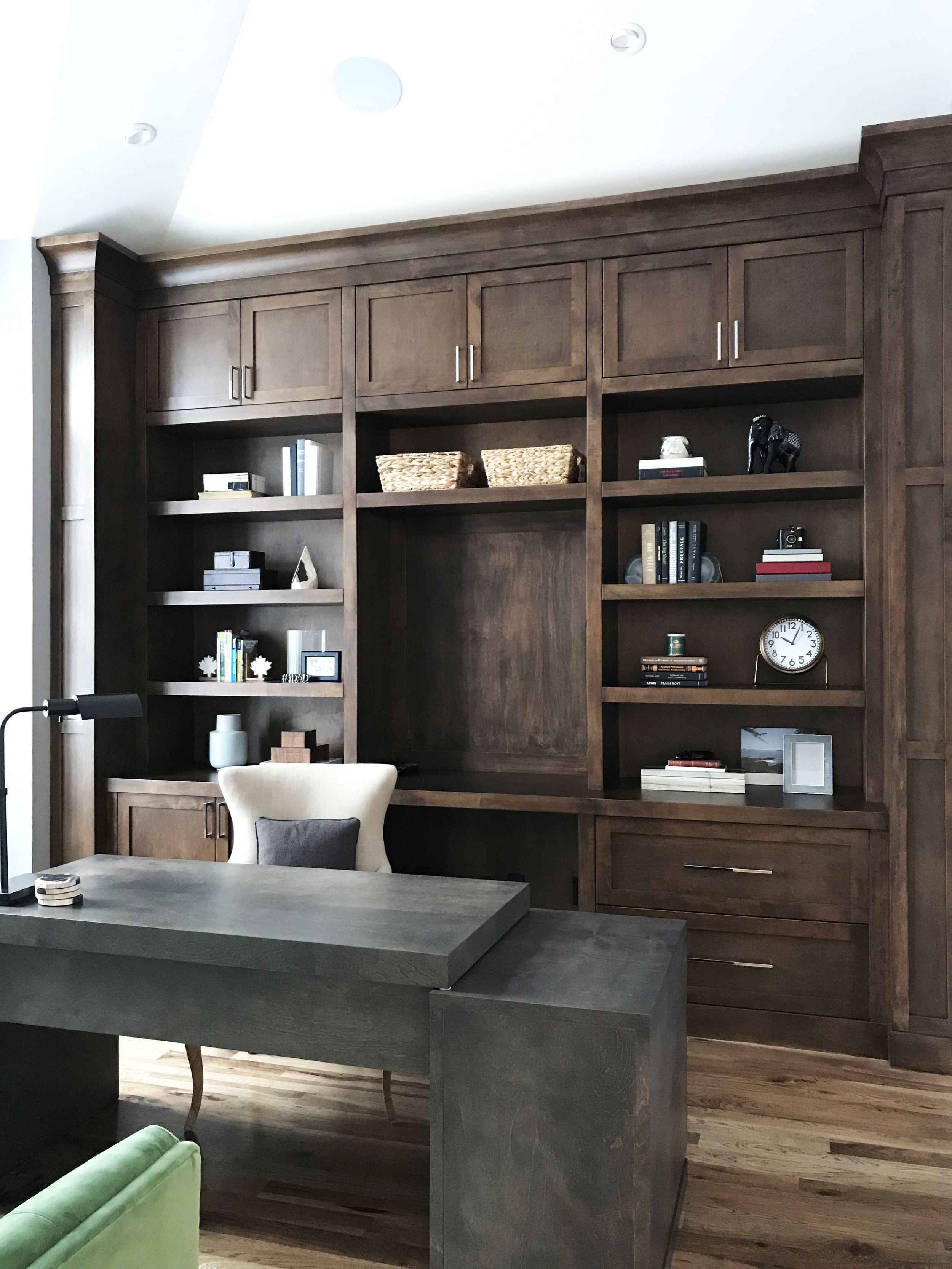 Home office with wood built-ins, floating desk and emerald green sofa. Interior Furnishings by Nyla Free Designs, Build by Veranda Estate Homes