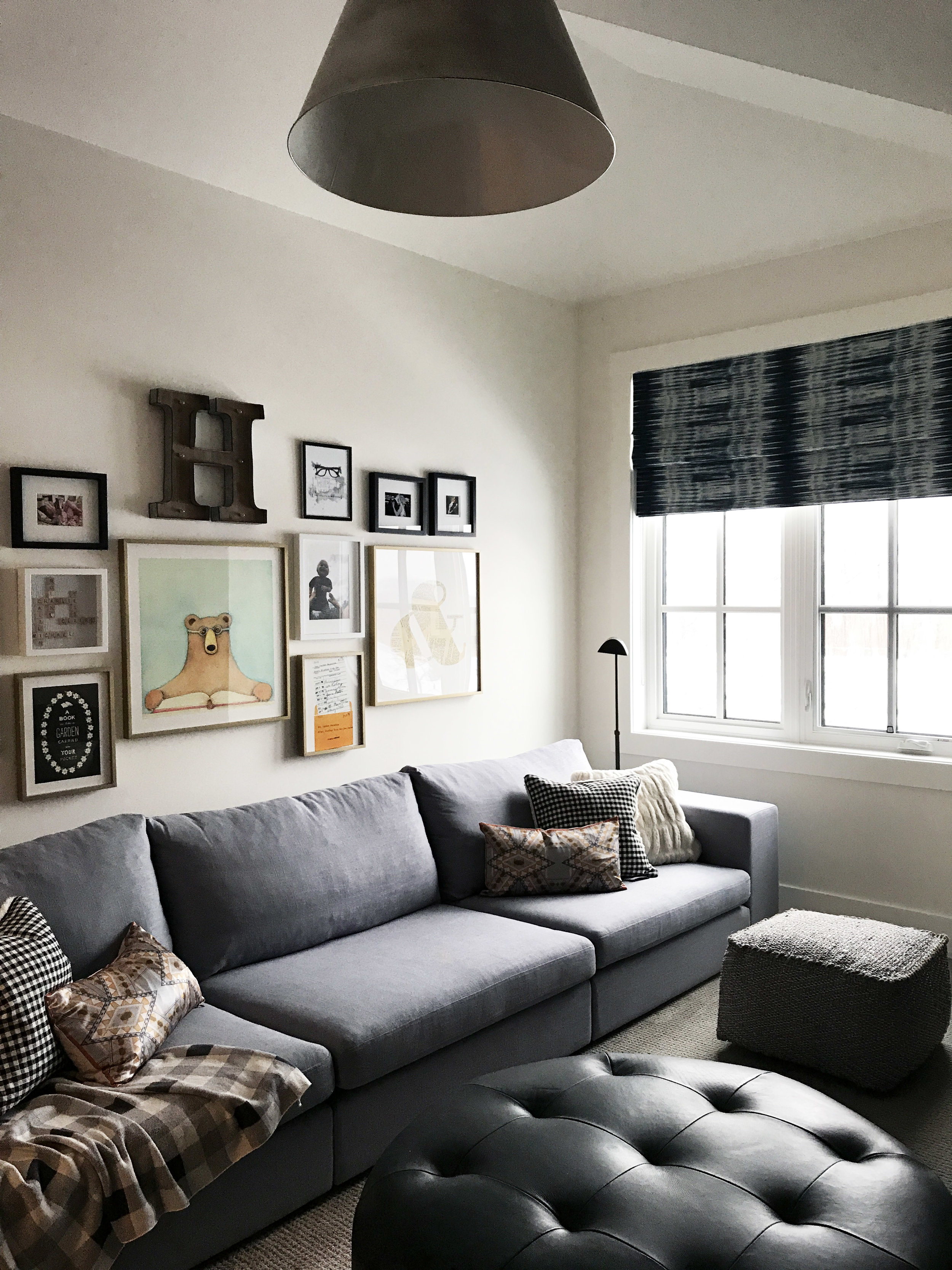 Family reading room with extra long sectional and gallery wall. Interior Furnishings by Nyla Free Designs, Build by Veranda Estate Homes