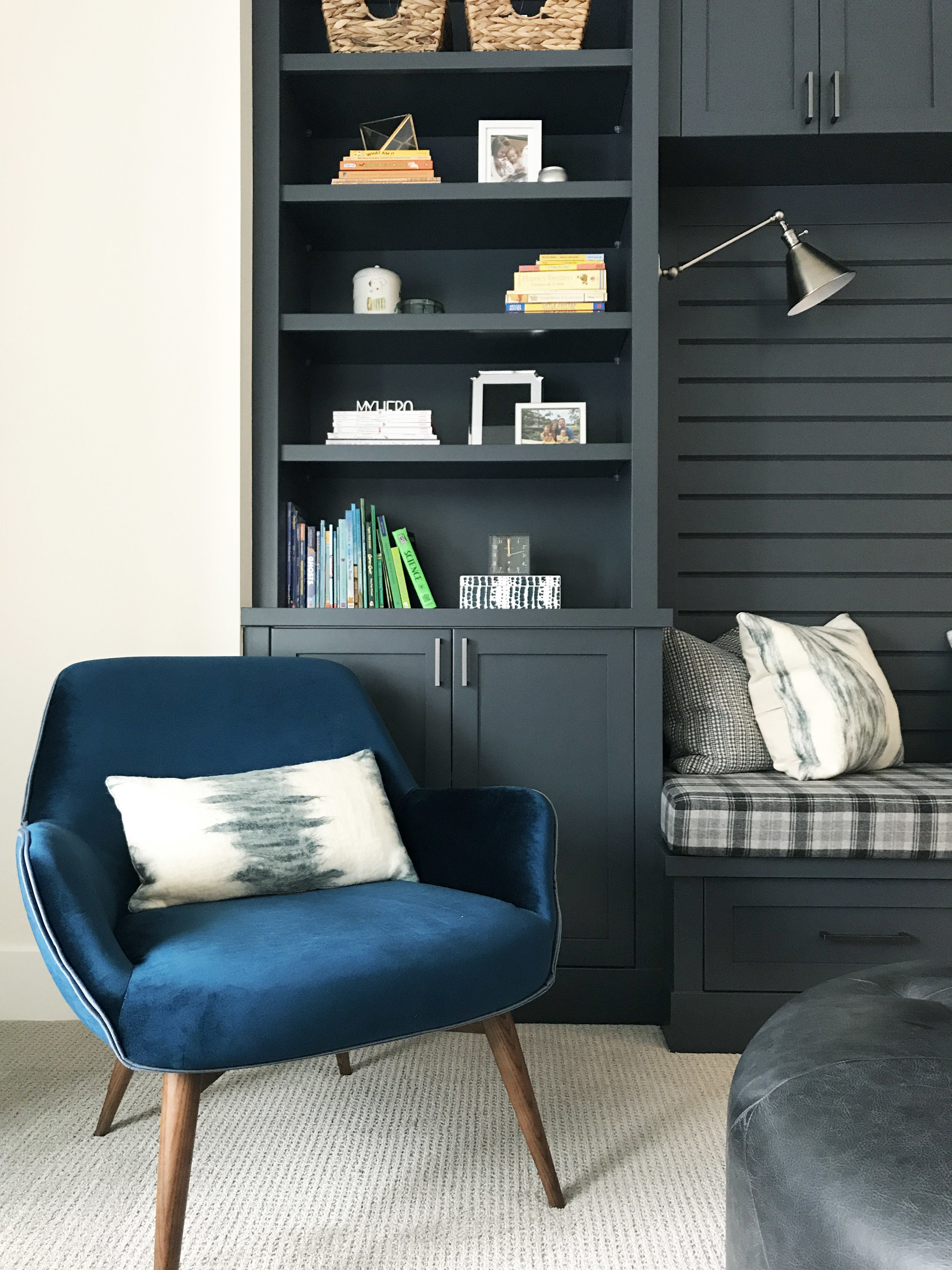 Family reading room with reading niche and blue velvet retro inspired chair. Interior Furnishings by Nyla Free Designs, Build by Veranda Estate Homes