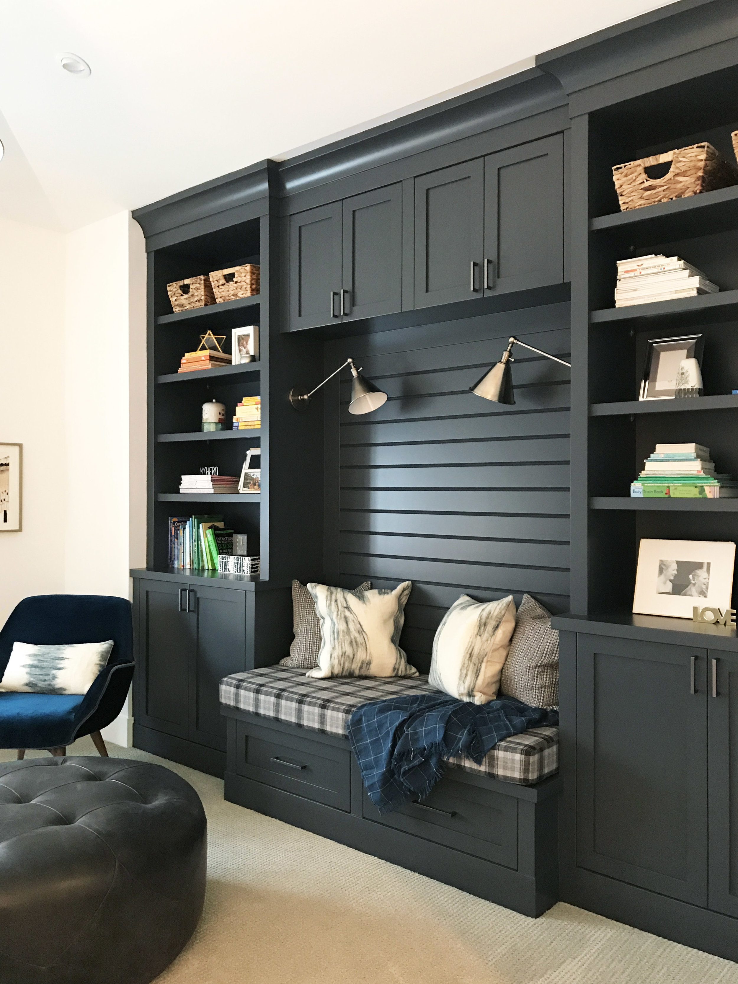 Family reading room with wall to wall built-in storage and reading nook. Interior Furnishings by Nyla Free Designs, Build by Veranda Estate Homes