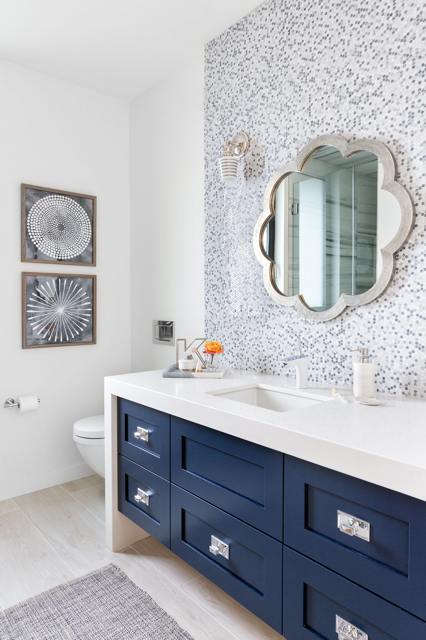 Girls Ensuite Bathroom, Navy Vanity with Shades of Grey and White Penny Round Backsplash, Flower Shaped Mirror, Elbow Park Modern, Nyla Free Designs, Calgary Interior Designer, DeJong Design Associates, Insignia Custom Homes, Phil Crozier Photography