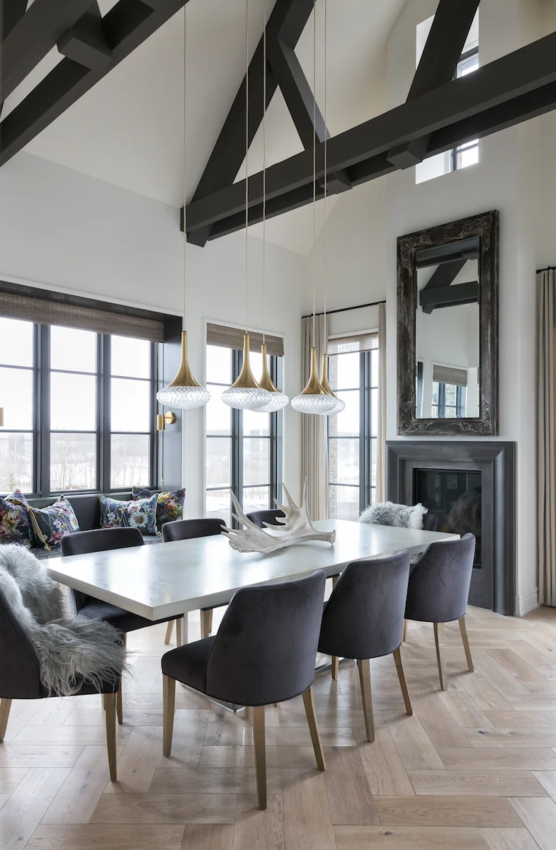 The Dining Room with exposed beams fireplace and seating for ten from a Rural Alberta Country House, Interior Design by Calgary Design Studio Nyla Free Designs Inc, Architecture: Dejong Design Associates, Photography: Phil Crozier #calgaryinteriordesign #calgaryinteriordesigner #nylafreedesigns #diningroominspirations #countryhouse