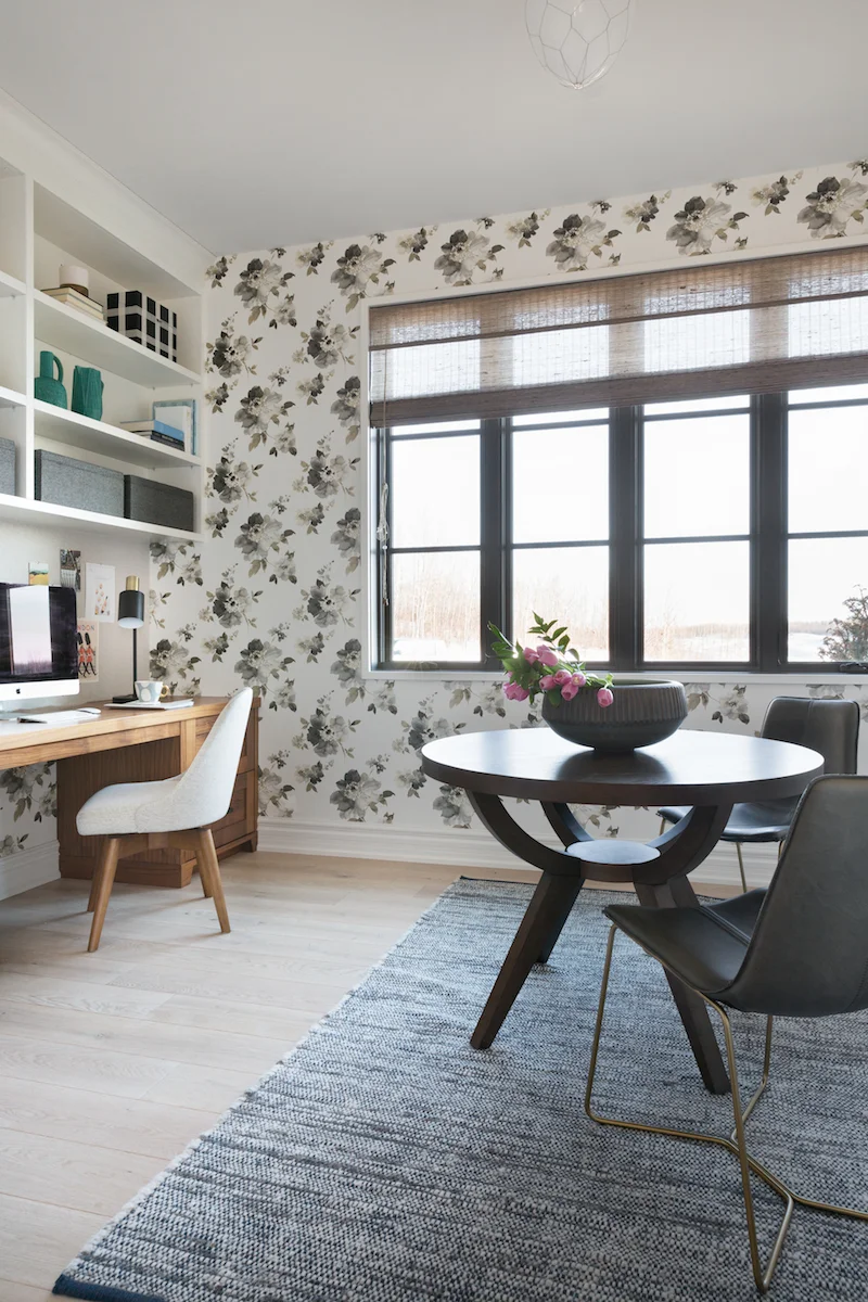 The wallpaper filled spacious home office with built-in desk and work table from a Rural Alberta Country House, Interior Design by Calgary Design Studio Nyla Free Designs Inc, Architecture: Dejong Design Associates, Photography: Phil Crozier #calgaryinteriordesign #calgaryinteriordesigner #nylafreedesigns #officeinspirations #countryhouse