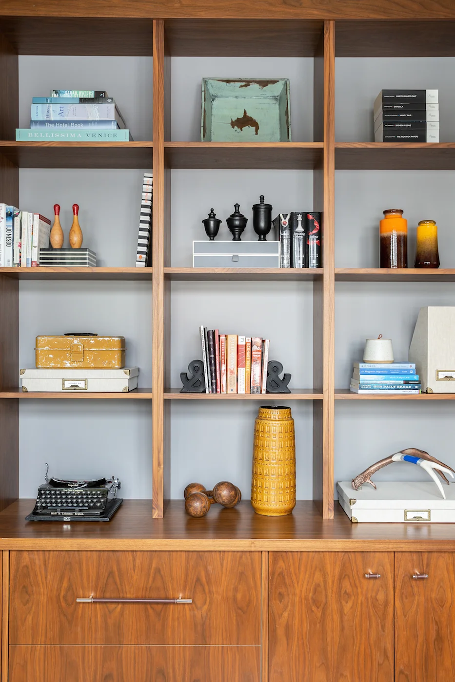 Detail shot of styled walnut shelving in the office space of an Elbow Park Residence, Interior Design by Calgary Design Studio: Nyla Free Designs, Photography: Phil Crozier #nylafreedesigns #nfdielbowparkluxe #officedesign #designinspirations