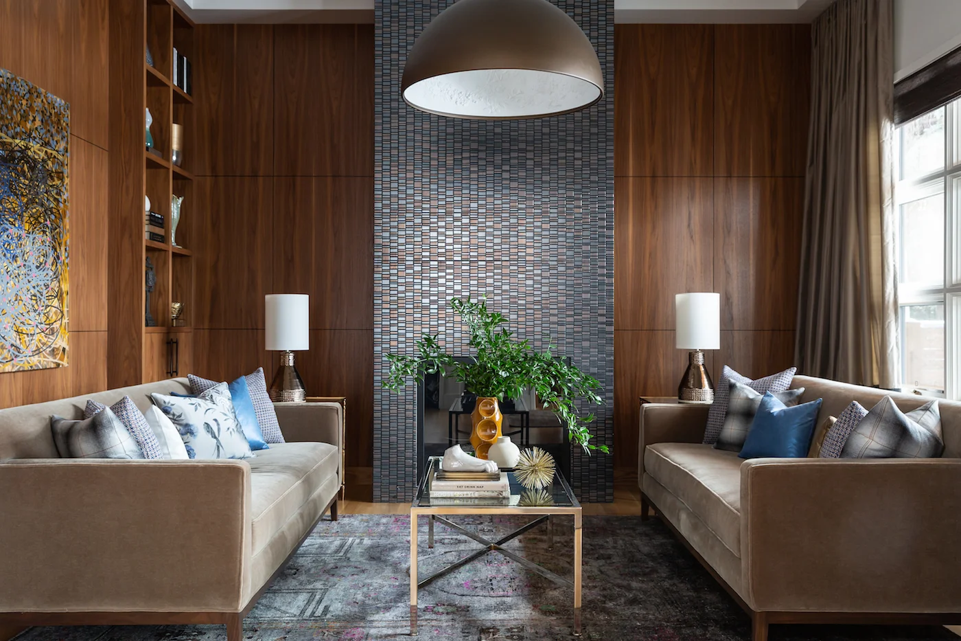 The sitting room with paired sofa’s framing fireplace, with walnut millwork from an Elbow Park Residence, Interior Design by Calgary Design Studio: Nyla Free Designs, Photography: Phil Crozier #nylafreedesigns #nfdielbowparkluxe #sittingroomdesign #