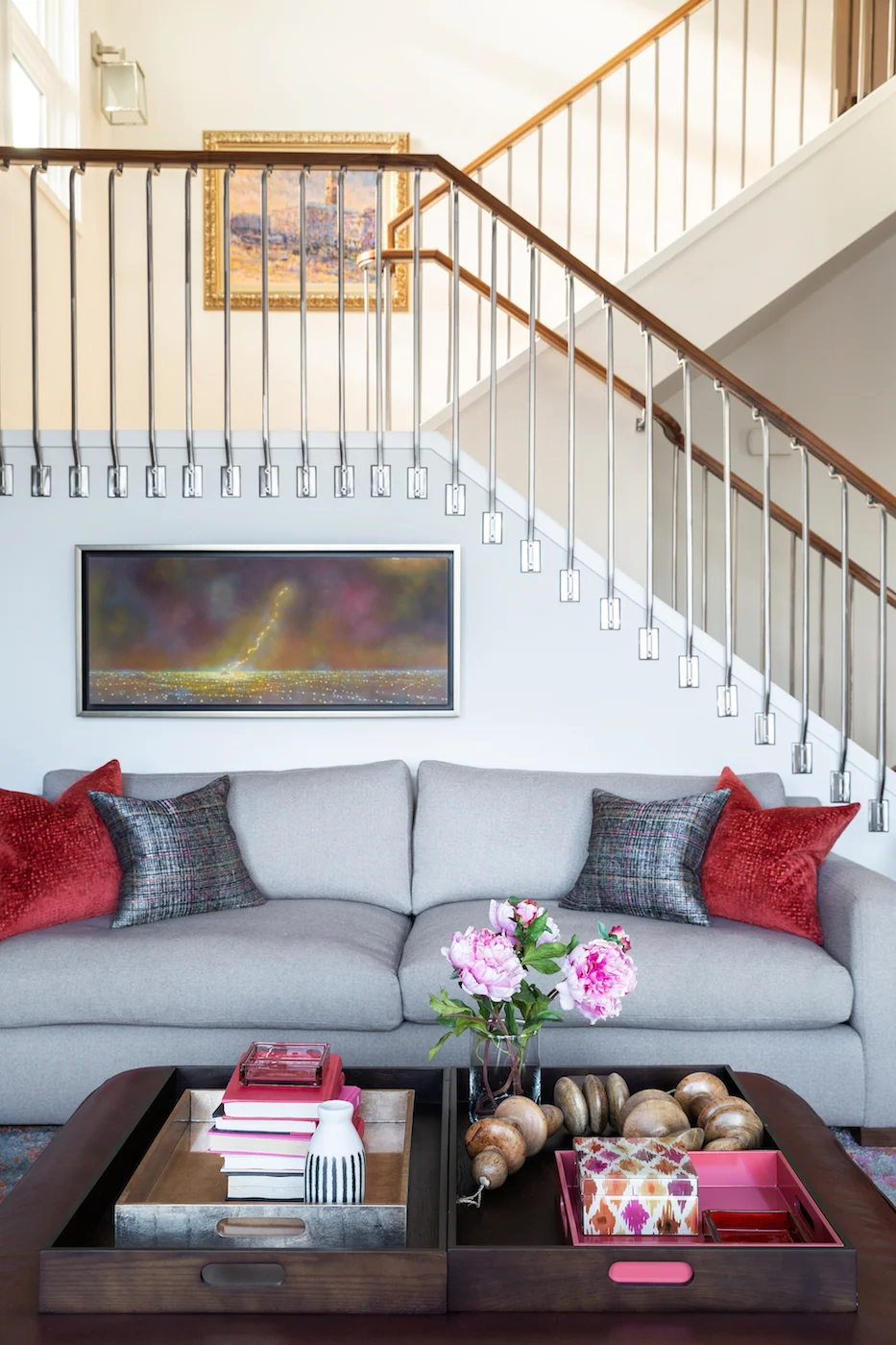 The Living Room with light grey sofa and styled coffee table onlooking staircase of an Elbow Park Residence, Interior Design by Calgary Design Studio: Nyla Free Designs, Photography: Phil Crozier #nylafreedesigns #nfdielbowparkluxe #livingroomdesign