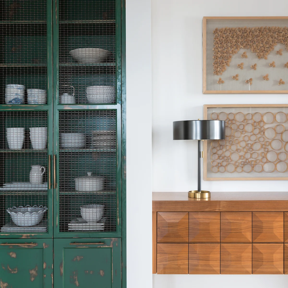 A built-in curio cabinet painted Kelly green with Floating walnut console in the dining room of a Rural Alberta Country House, Interior Design by Calgary Design Studio Nyla Free Designs Inc, Photography: Phil Crozier #calgaryinteriordesign #calgaryi