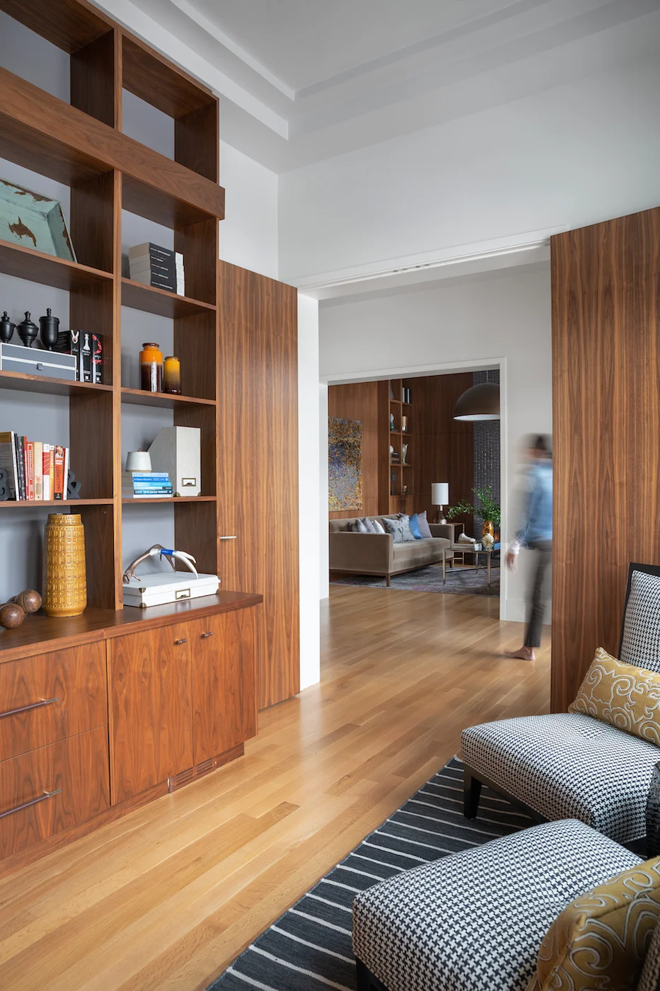 Bright office space looking into sitting room with warm wood tones, and styled shelving unit from an Elbow Park Residence, Interior Design by Calgary Design Studio: Nyla Free Designs, Photography: Phil Crozier #nylafreedesigns #nfdielbowparkluxe #of