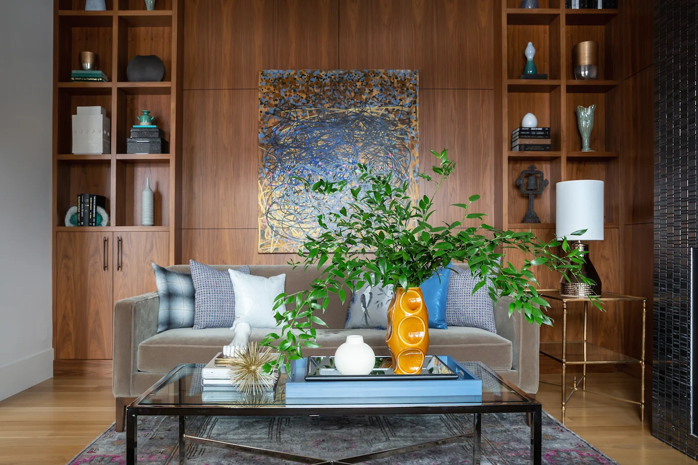 The sitting room with paired sofa’s framing fireplace, large scale artwork and walnut millwork from an Elbow Park Residence, Interior Design by Calgary Design Studio: Nyla Free Designs, Photography: Phil Crozier #nylafreedesigns #nfdielbowparkluxe #sittingroomdesign #designinspirations