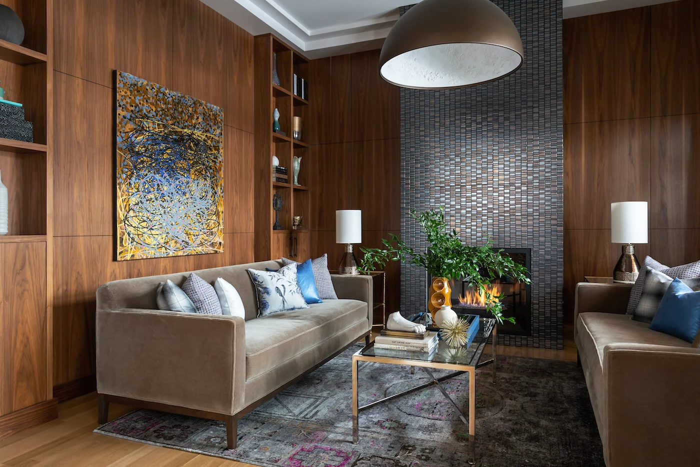 The sitting room with paired sofa’s framing fireplace, with walnut millwork from an Elbow Park Residence, Interior Design by Calgary Design Studio: Nyla Free Designs, Photography: Phil Crozier #nylafreedesigns #nfdielbowparkluxe #sittingroomdesign #designinspirations
