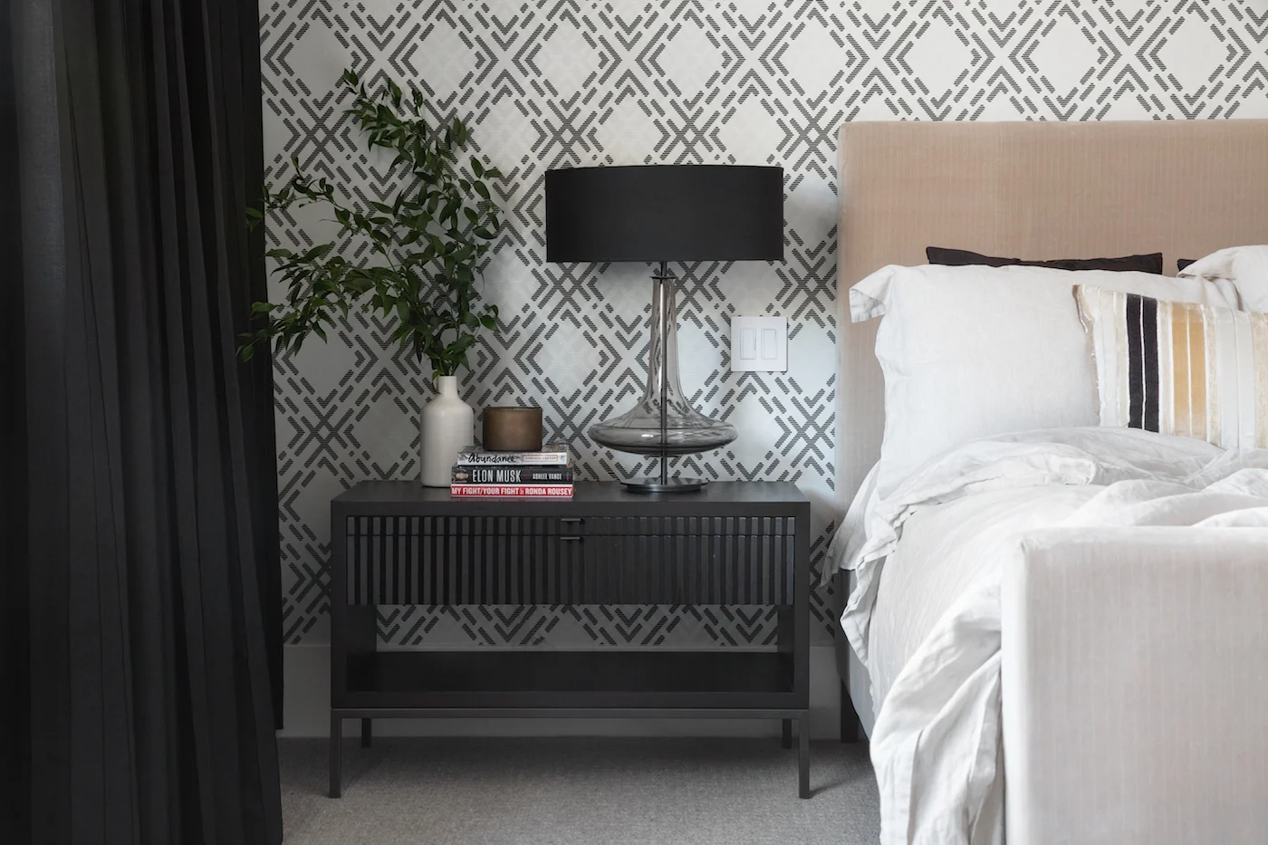 The master bedroom featuring wallpaper, styled black nightstands and custom drapery from an Elbow Park Residence, Interior Design by Calgary Design Studio: Nyla Free Designs, Photography: Phil Crozier #nylafreedesigns #nfdielbowparkluxe #masterbedroomdesign #designinspirations