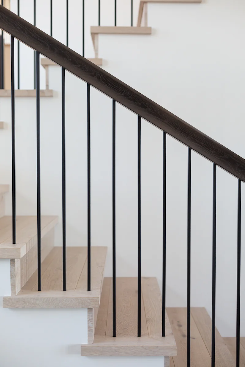 A staircase detail from a Rural Alberta Country House, Interior Design by Calgary Design Studio Nyla Free Designs Inc, Architecture: Dejong Design Associates, Photography: Phil Crozier #calgaryinteriordesign #stairwaytoheaven #calgaryinteriordesigner #nylafreedesigns #livingessentials #countryhouse