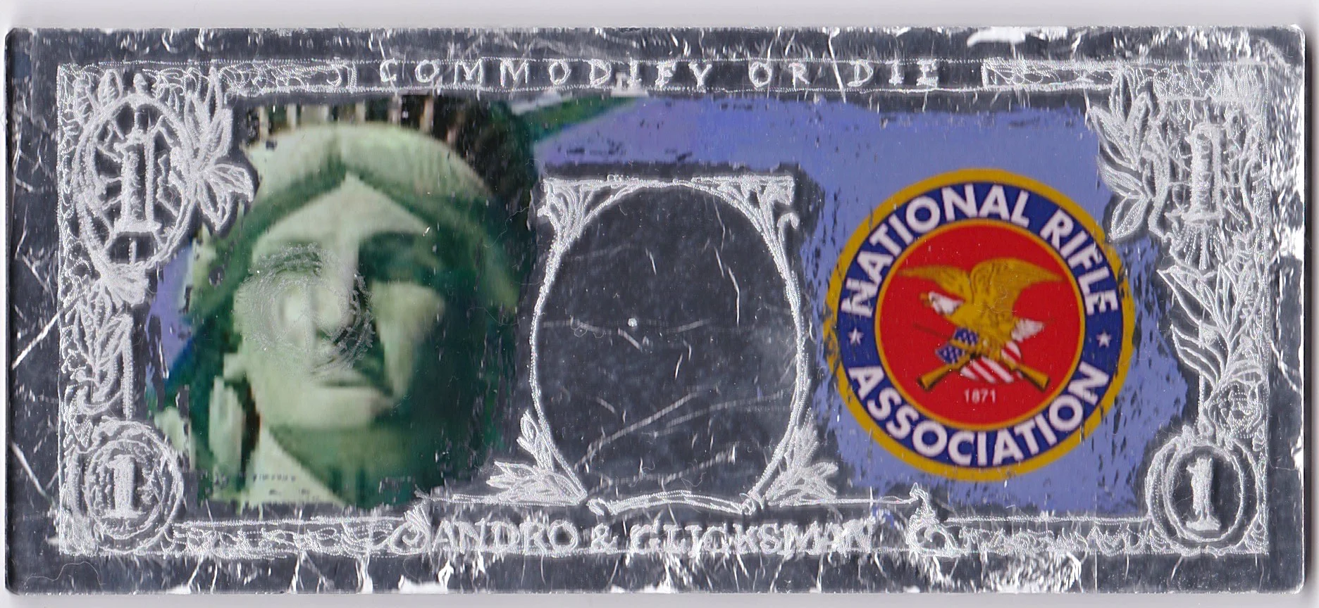  Commodify or Die - “NRA”  Italian aluminum leaf on engraved plexiglass with photo collage on paper  2 5/8” x 6 1/8” x 1/4” &nbsp; 2025 