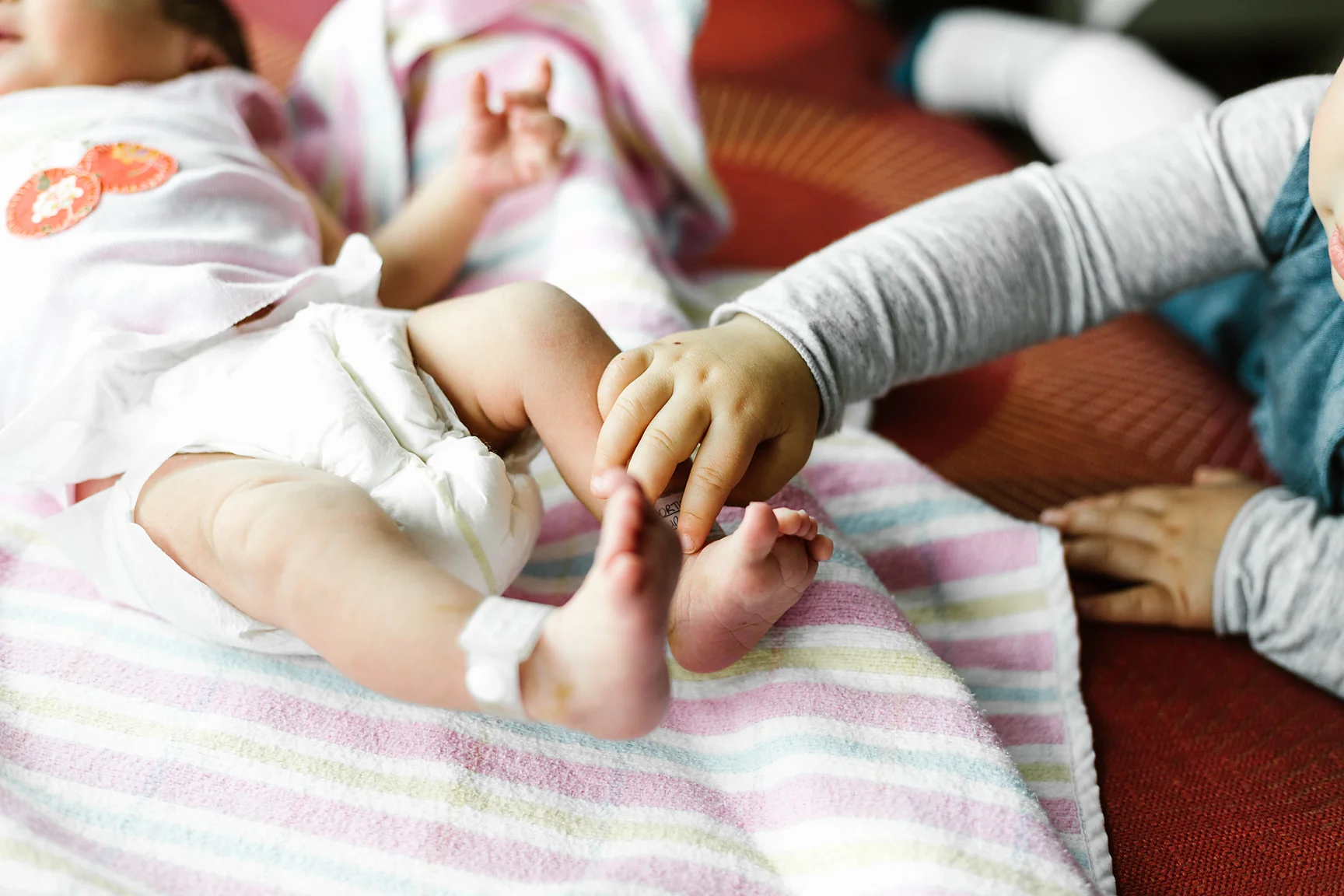 Perhaps Big Sister Florence shares our obsession with baby feet <3