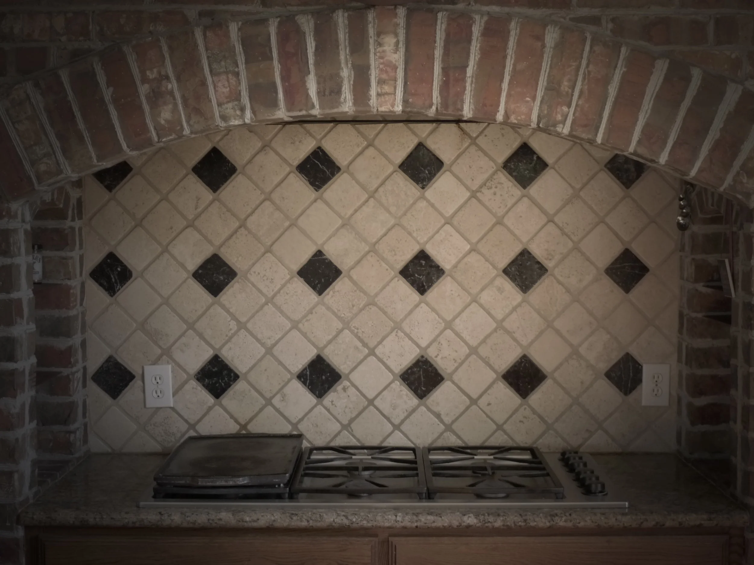Stove w/ Brick Surround + Granite Counter