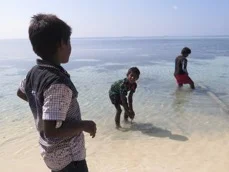 Surveying where trash was recently disposed on Bodufolhudhoo, compared to where it is currently burned, adjacent to a swimming beach.