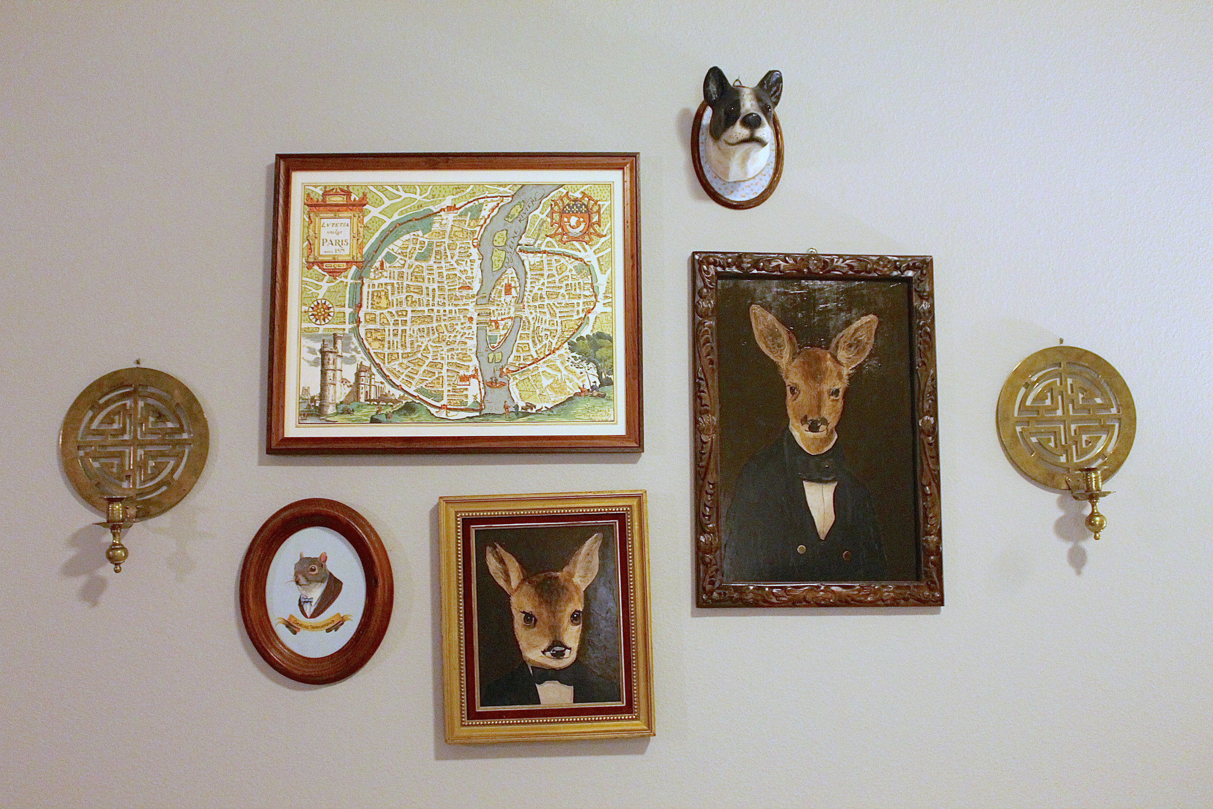 Pieces from the gallery wall above my sofa have been collected over the span of many years. (Note to self: buy candles for sconces.)
