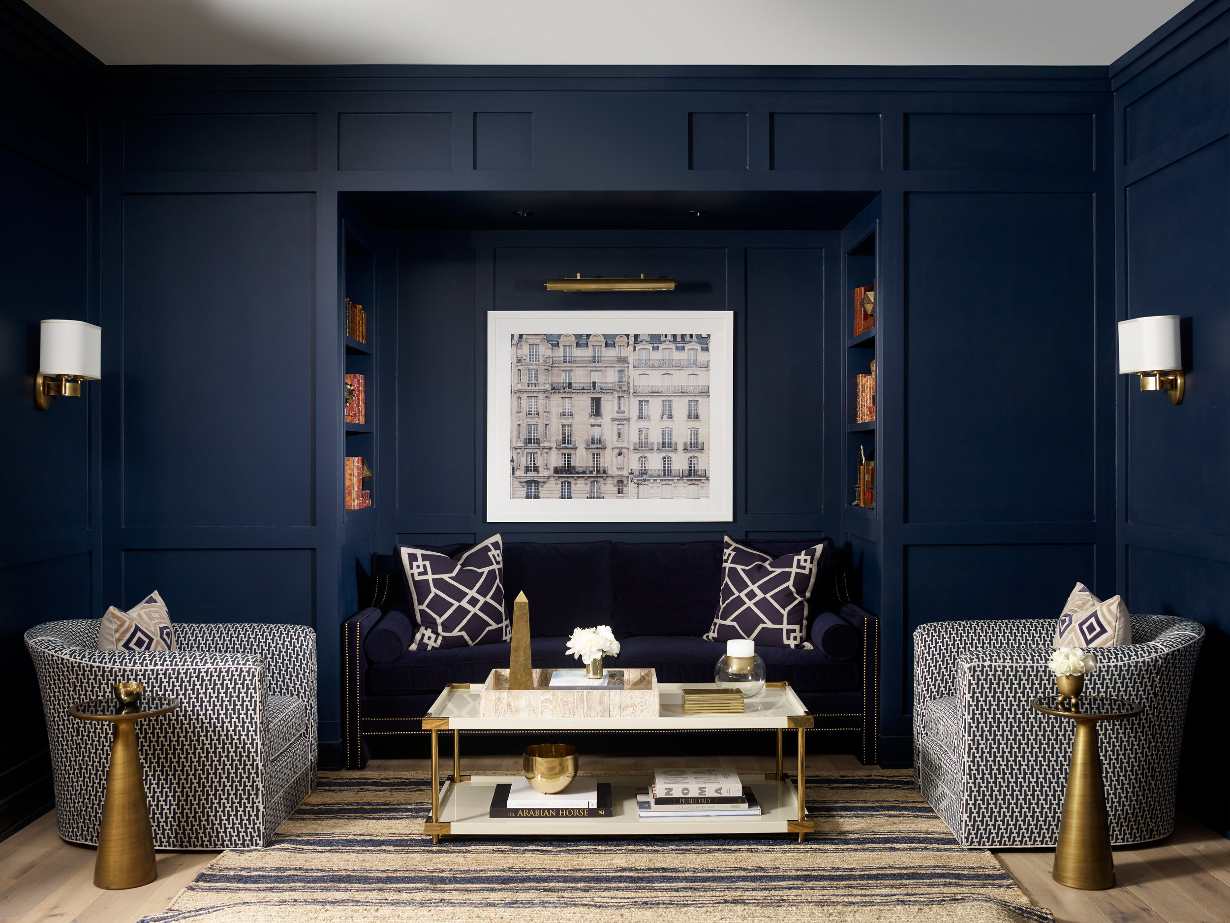 I love the pop of orange of the books in the niches flanking the sofa.