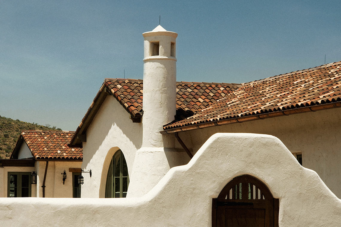 Rancho Del Cielo: "Soft white plaster walls provide contrast with the natural surroundings, while the red clay tile roof anchors the house to the landscape."