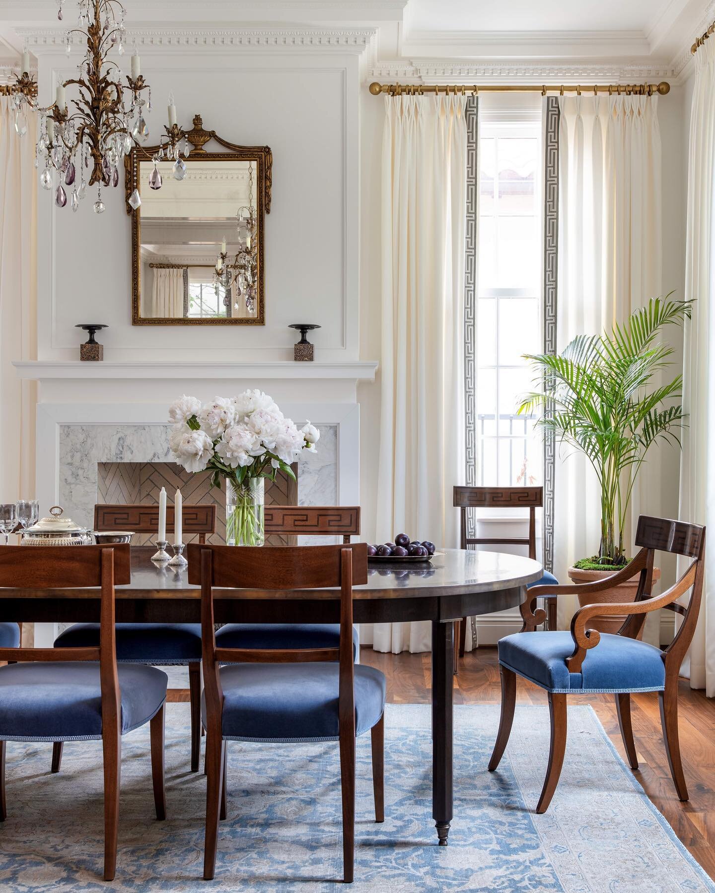 Starting with this dreamy set of velvet Greek key chairs, everything in this bright formal dining room fell right into place. The brass banding around the custom ebony table and the neoclassical mirror are just a few of my favorite details. And of co