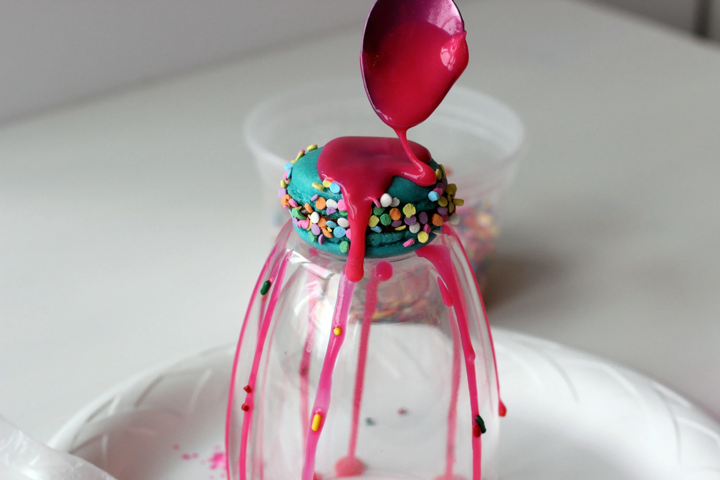 Step 4: Drizzle pink ganache over macaron.