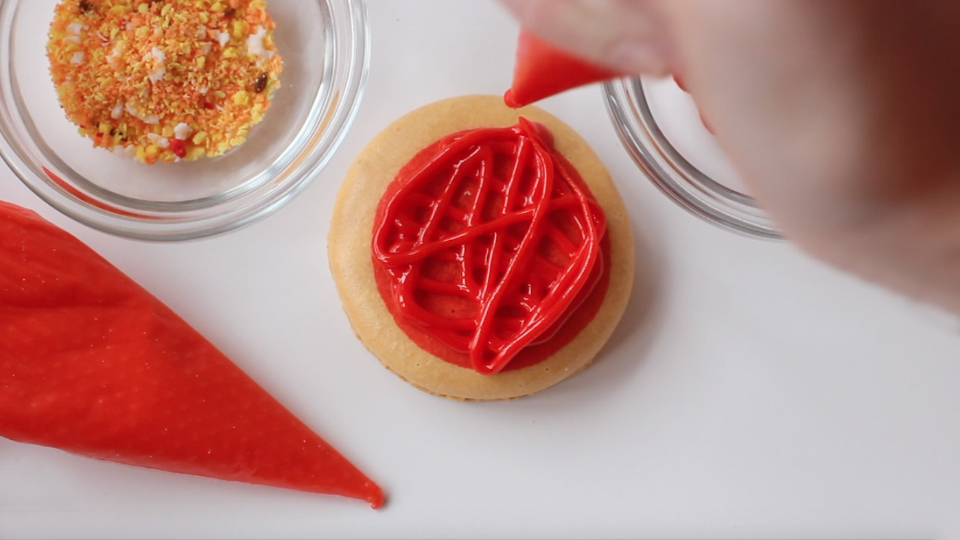 Step 2: Pipe macarons with royal icing.