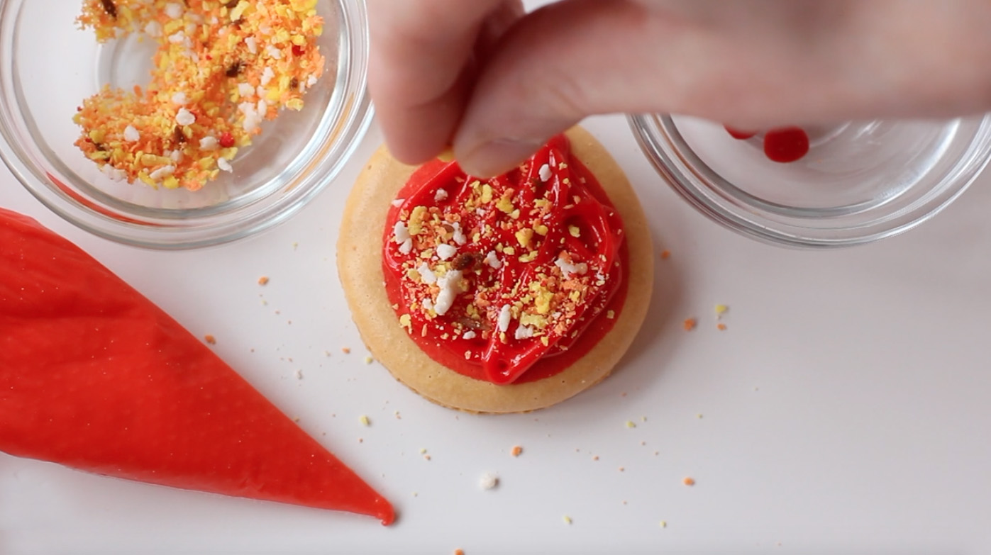 Step 3: Sprinkle "cheese" onto macarons.