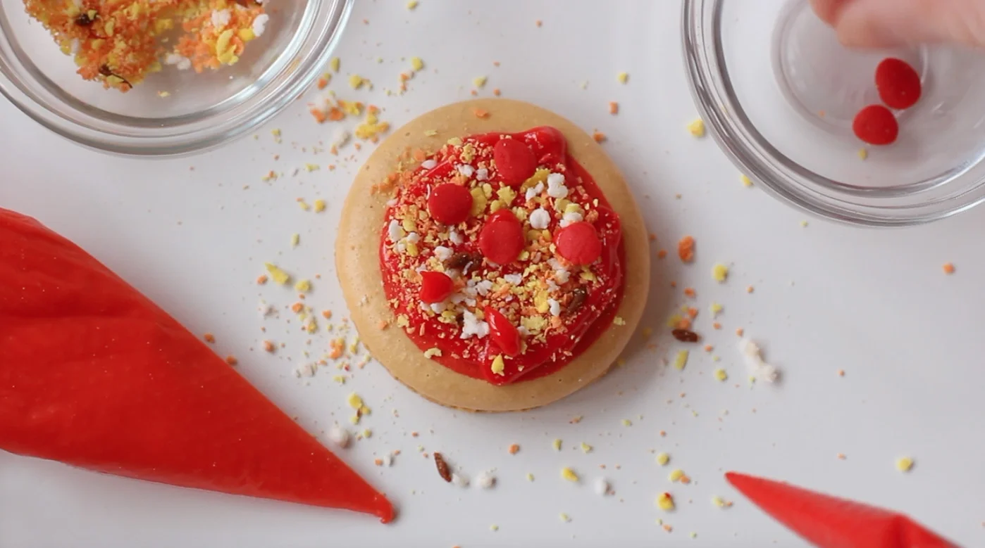 Step 4: Place fondant pepperonis on macaron.