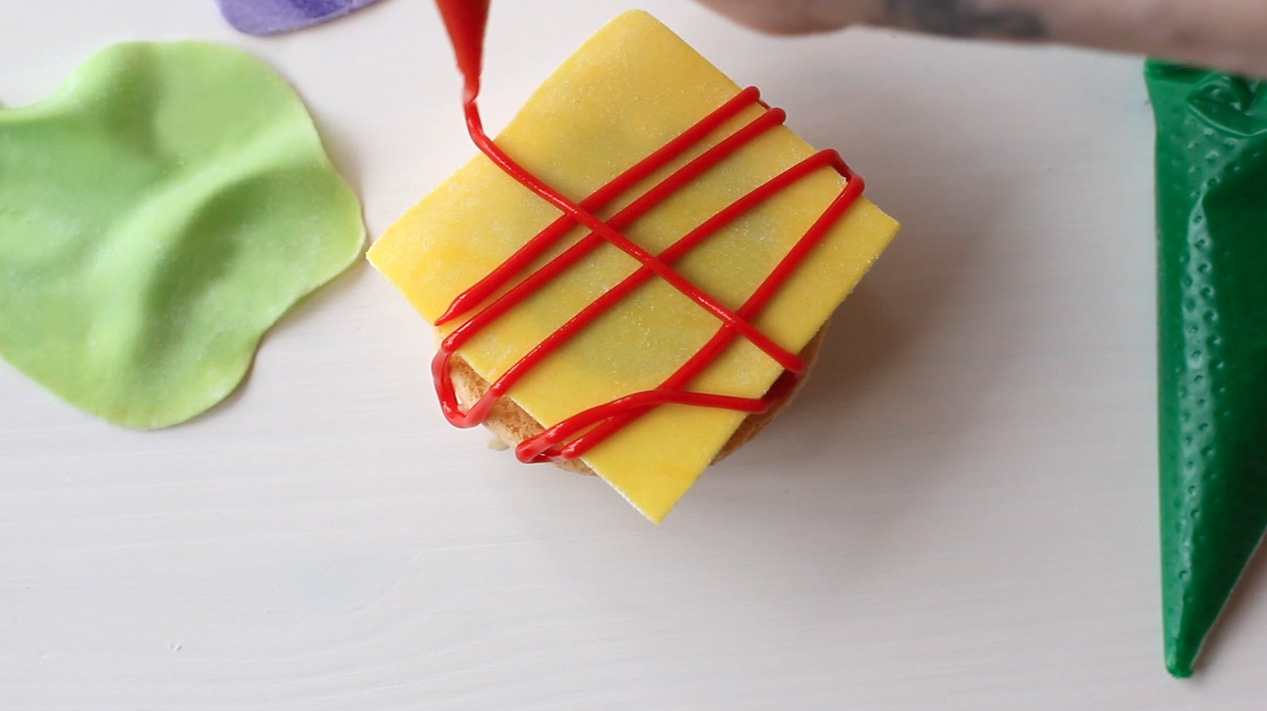 Step 4: Pipe condiments onto cheese slice.