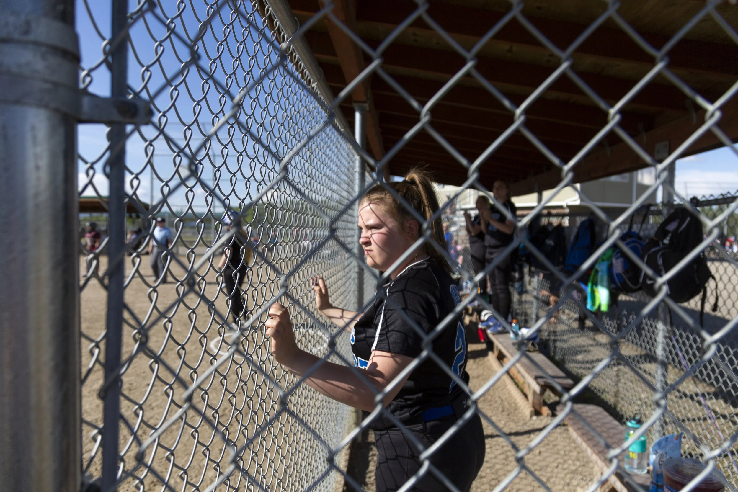 #27 Morgan Poole watches her teammates on the field in the Thunder Mountain vs Ketchikan double elimination championship game on Saturday, June 2nd in Fairbanks, AK. Sarah Manriquez/Juneau Empire