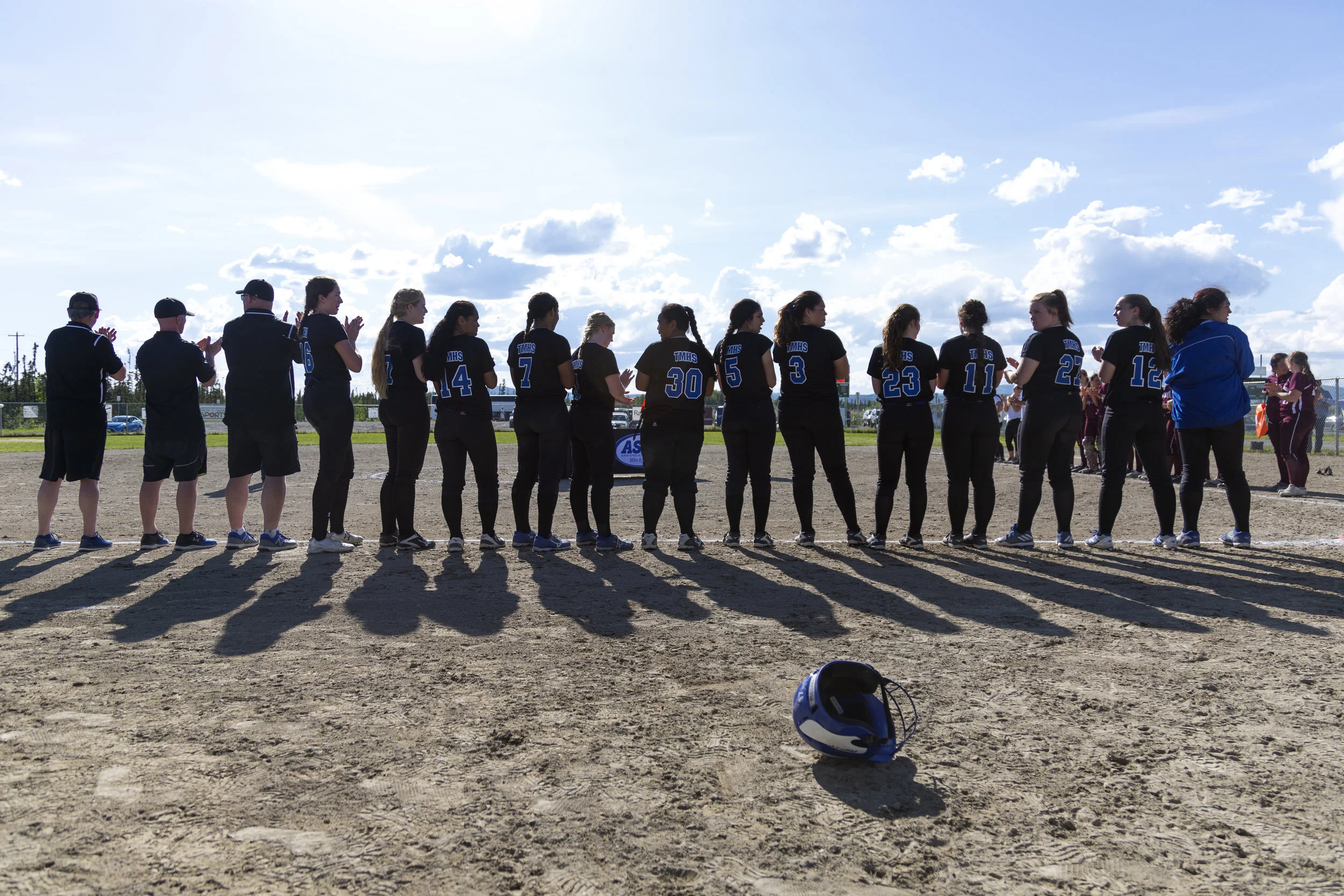 The Thunder Mountain Falcons softball team lines up for the award ceremony at the ASAA Division II state softball tournament in Fairbanks where they won the state championship for the third year in a row. Sarah Manriquez/Juneau Empire