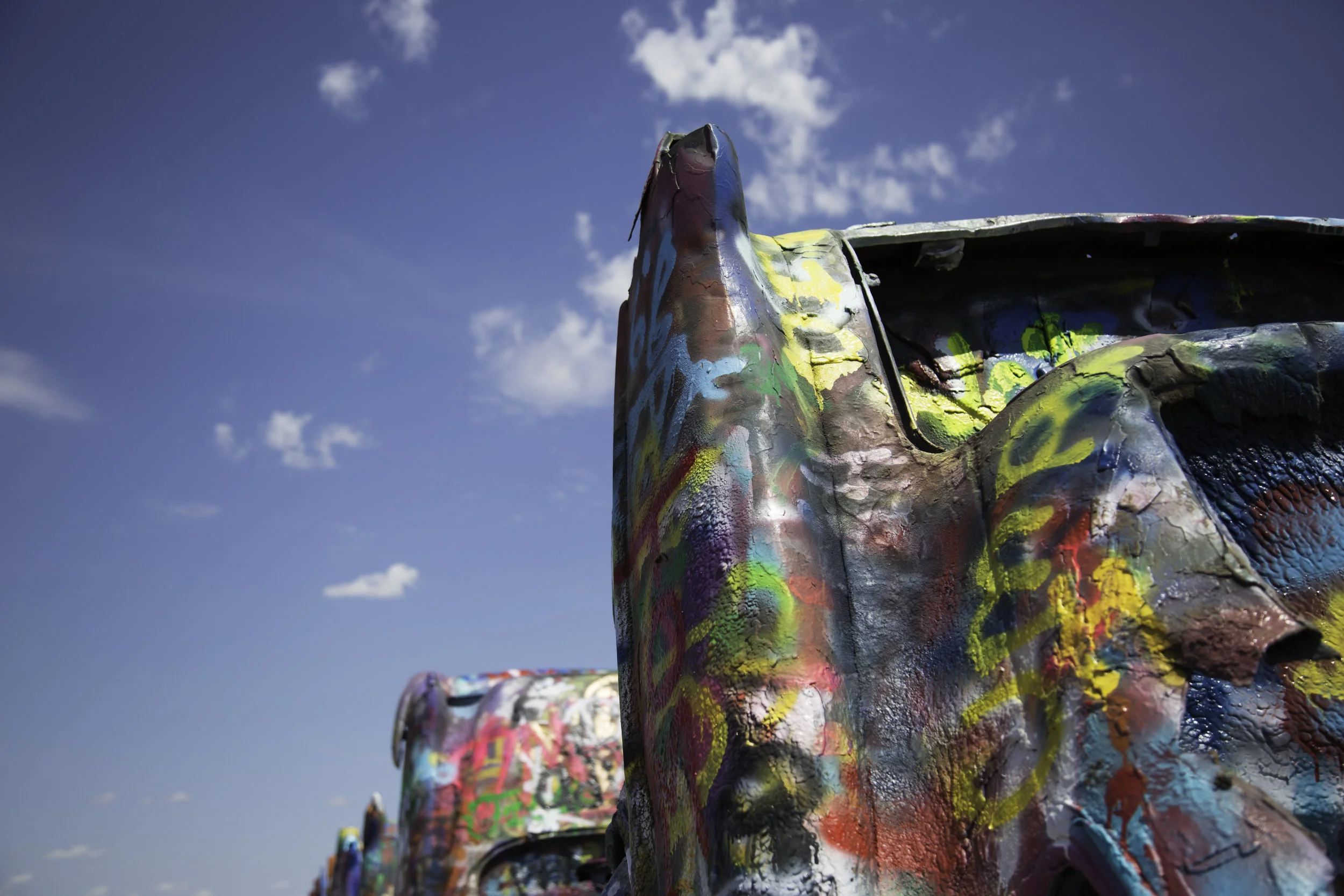 he Cadillac Ranch is a public art installation put into place in 1974 by Chip Lord, Hudson Marquez and Doug Michels. They used older, “junk” cadillacs that represented the evolution of the car line from 1949 to 1963. The vehicles were half buried into the ground at an angle that corresponded to that of the Great Pyramid of Giza in Egypt.