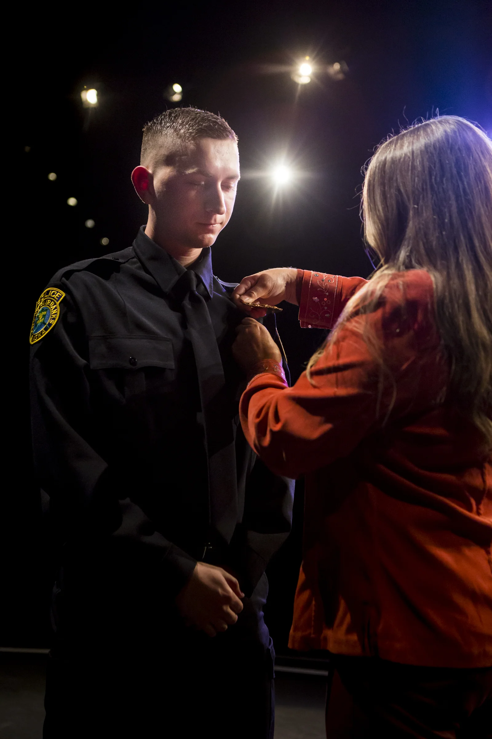 Christian Pergande his badge during the pinning ceremony at the Community and Technical College Police Academy graduation on Friday, October 12th, 2018.