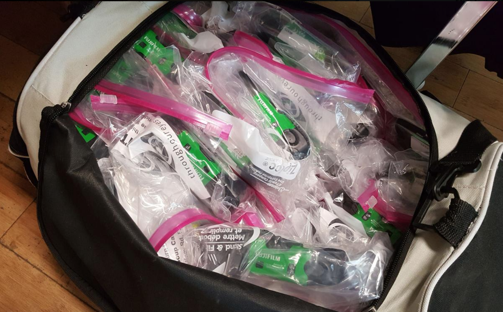  A bag of 100 disposable Fuji cameras sits waiting for distribution. Gary Black / Fairbanks Daily News Miner 