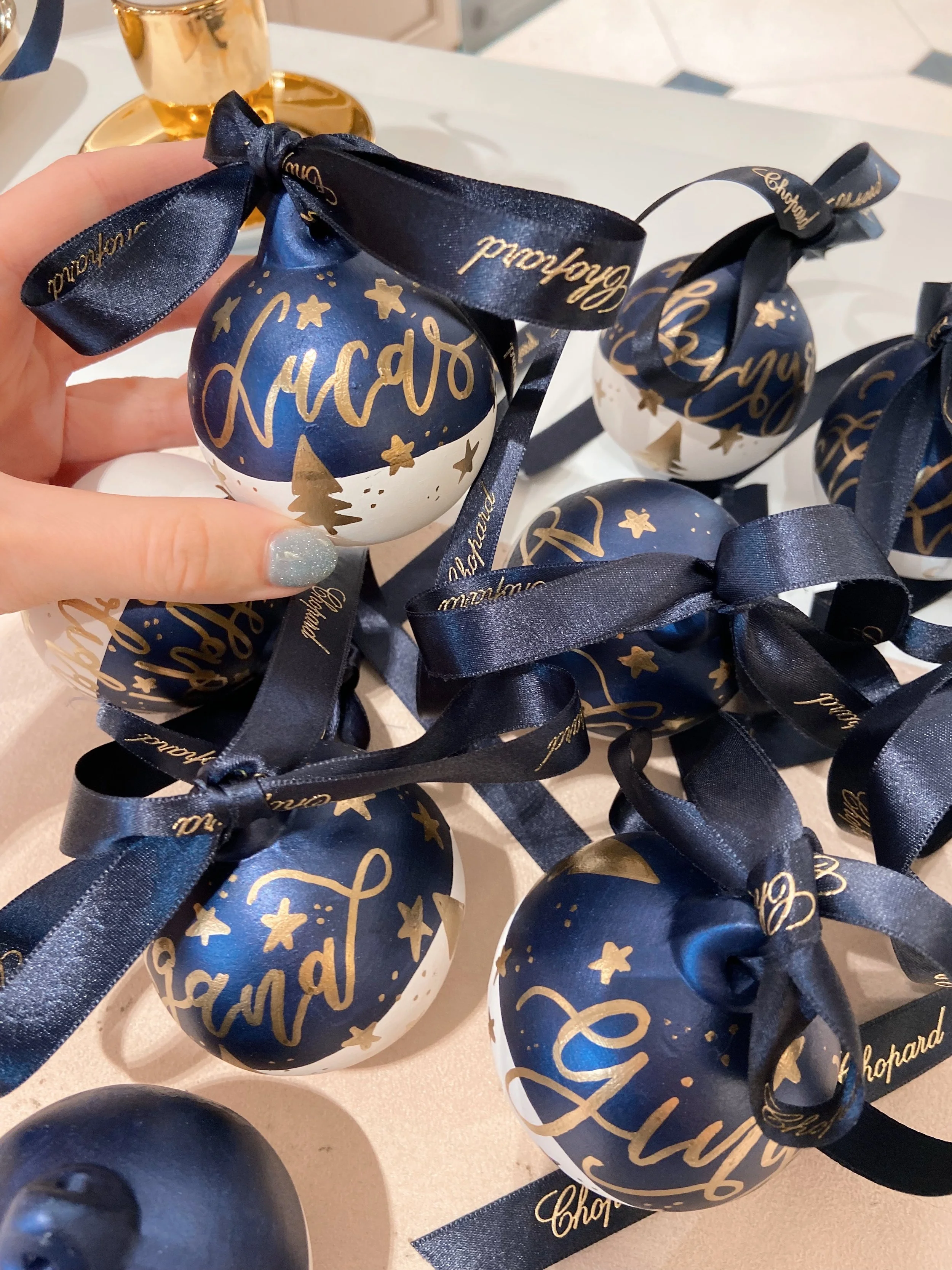 Live calligraphy on ceramic baubles 
