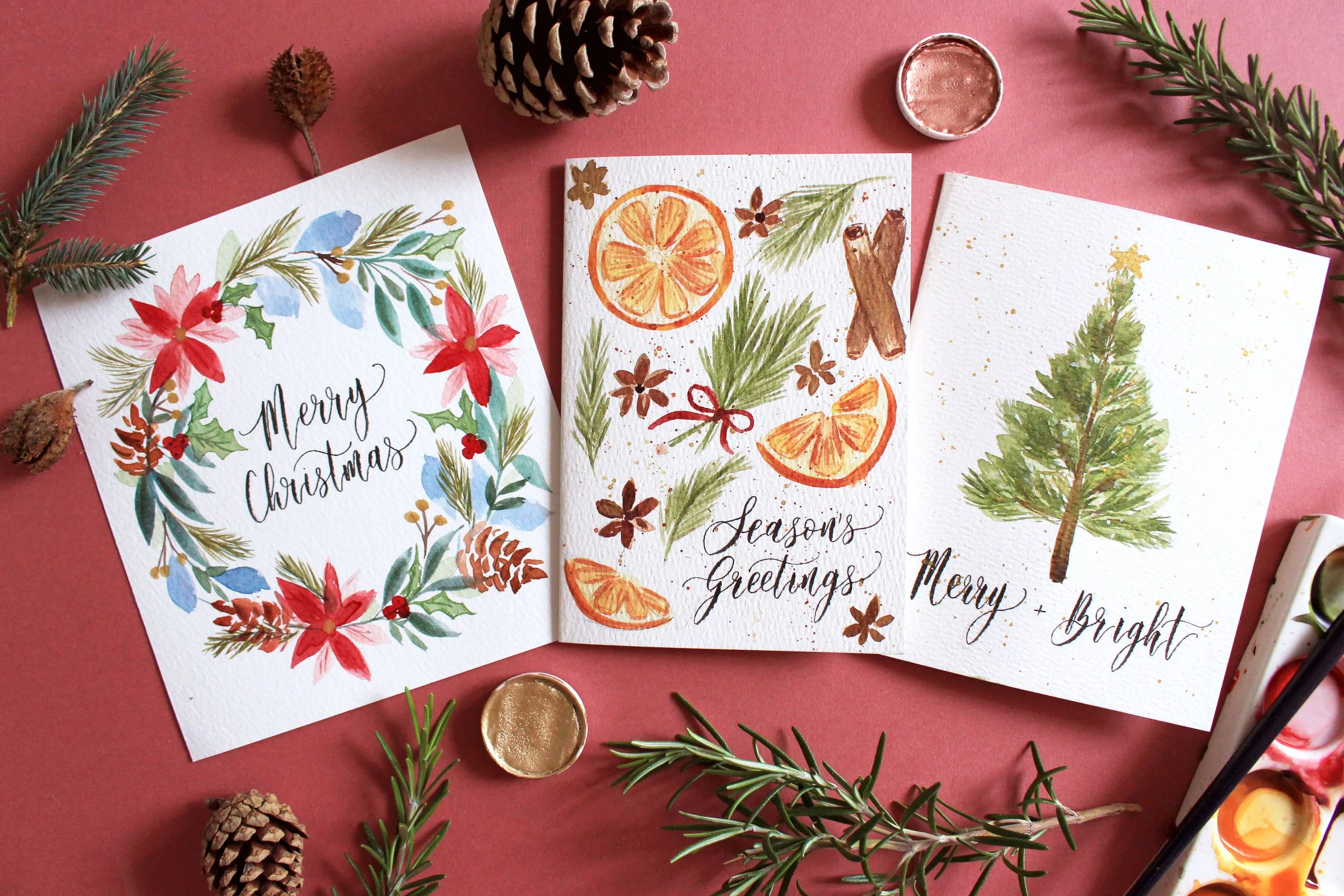 Christmas watercolour and brush calligraphy cards workshop featuring a festive wreath, orange and cinnamon sticks, and a Christmas tree with gold details. (Copy)