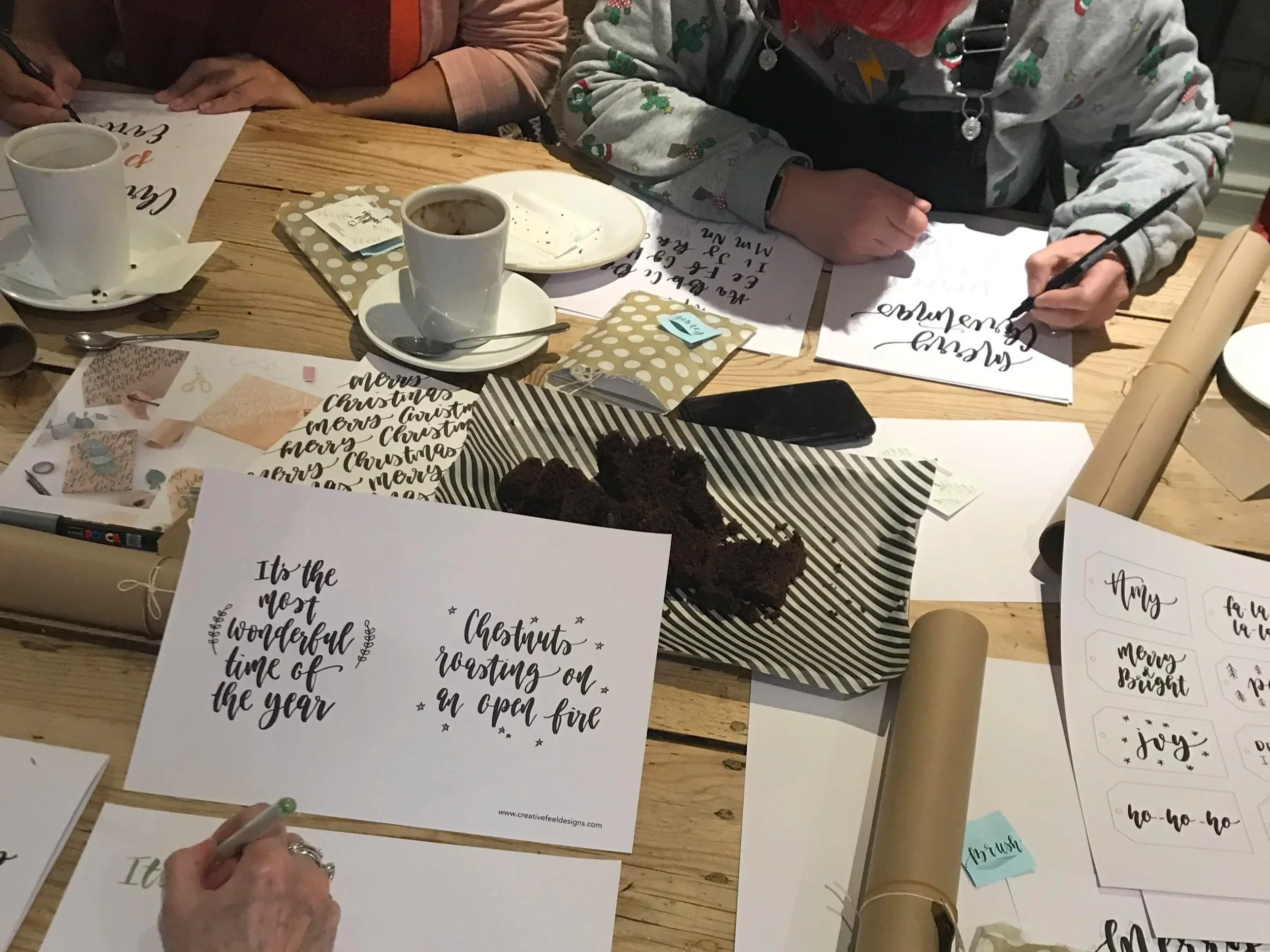 Christmas brush calligraphy workshop setup at Gail’s Bakery Hove with festive decorations and lettering supplies