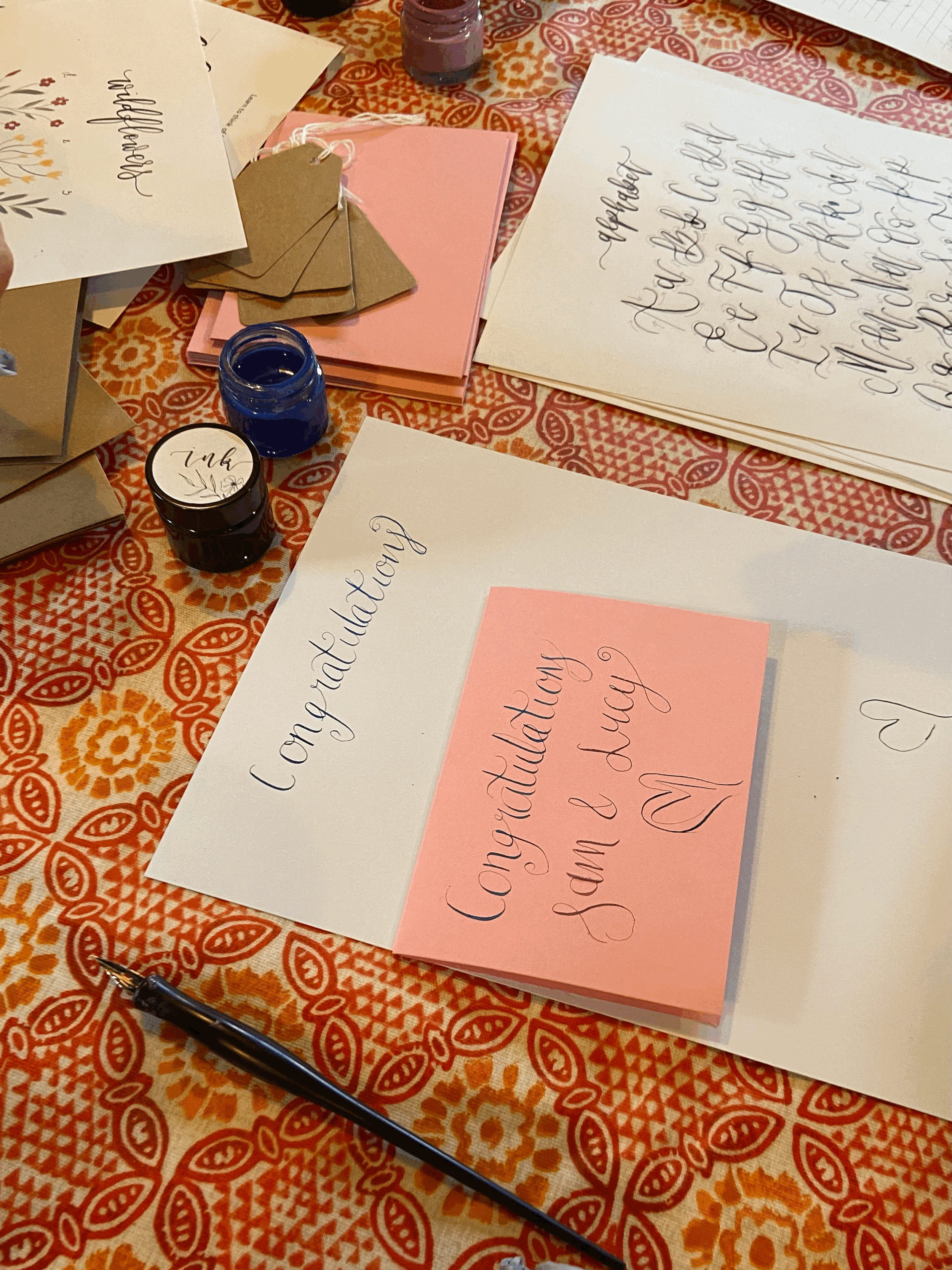Calligraphy class setup with nibs, ink, and worksheets”