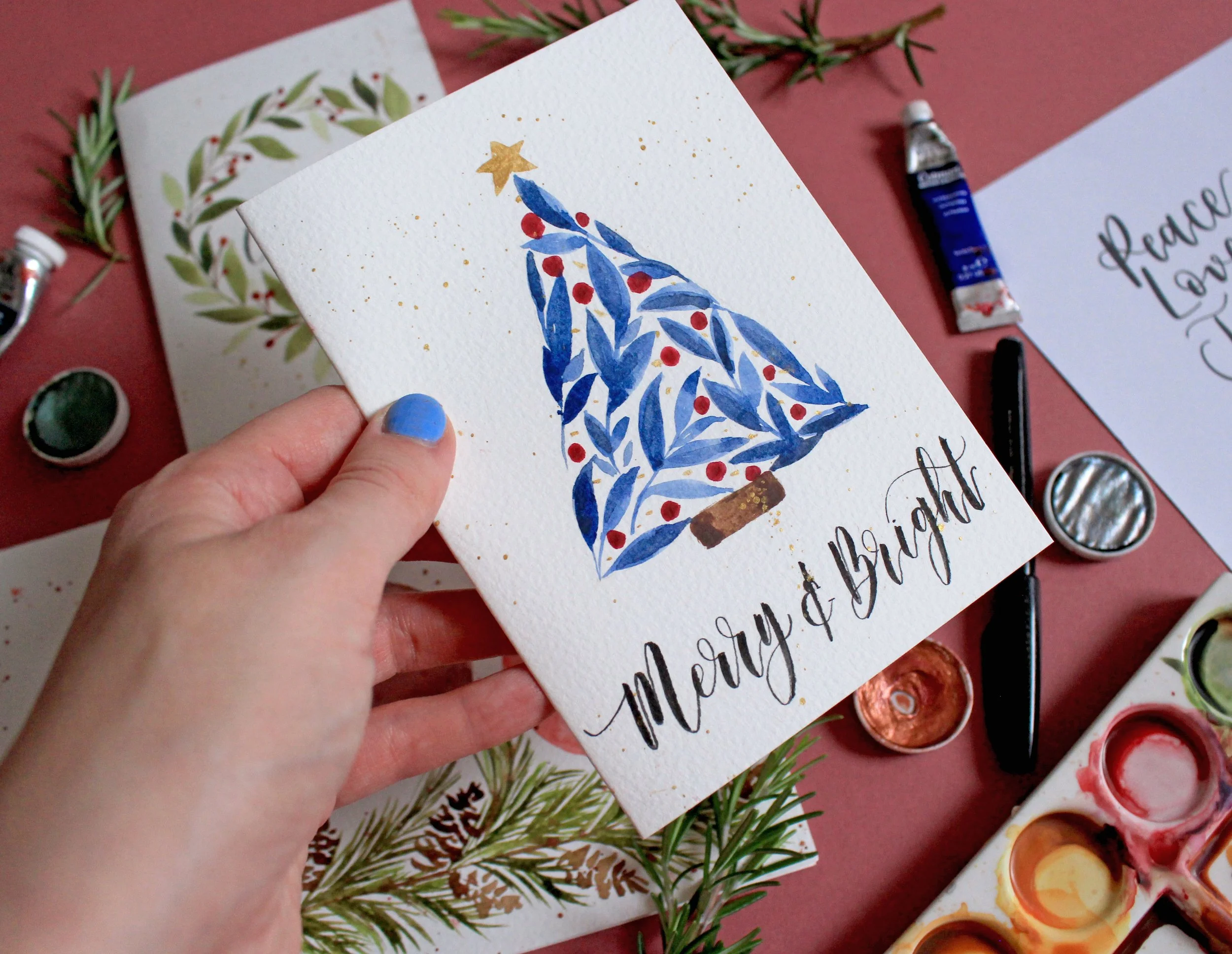 Modern brush calligraphy Christmas greeting on a handmade festive card.