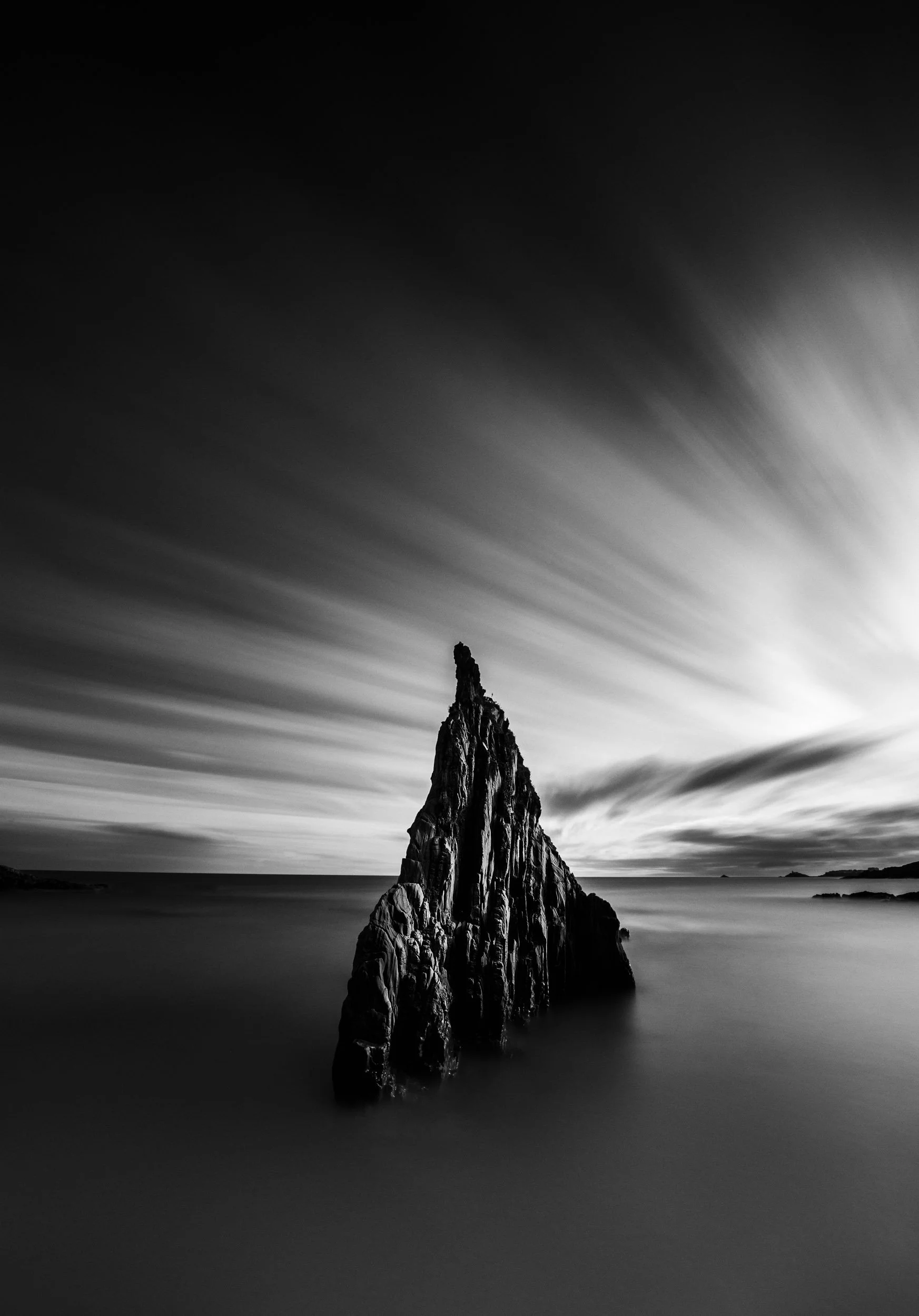 Long exposure of the triangular rock formation in black and white at the playa de mexota in the region of Asturias in northern Spain. 