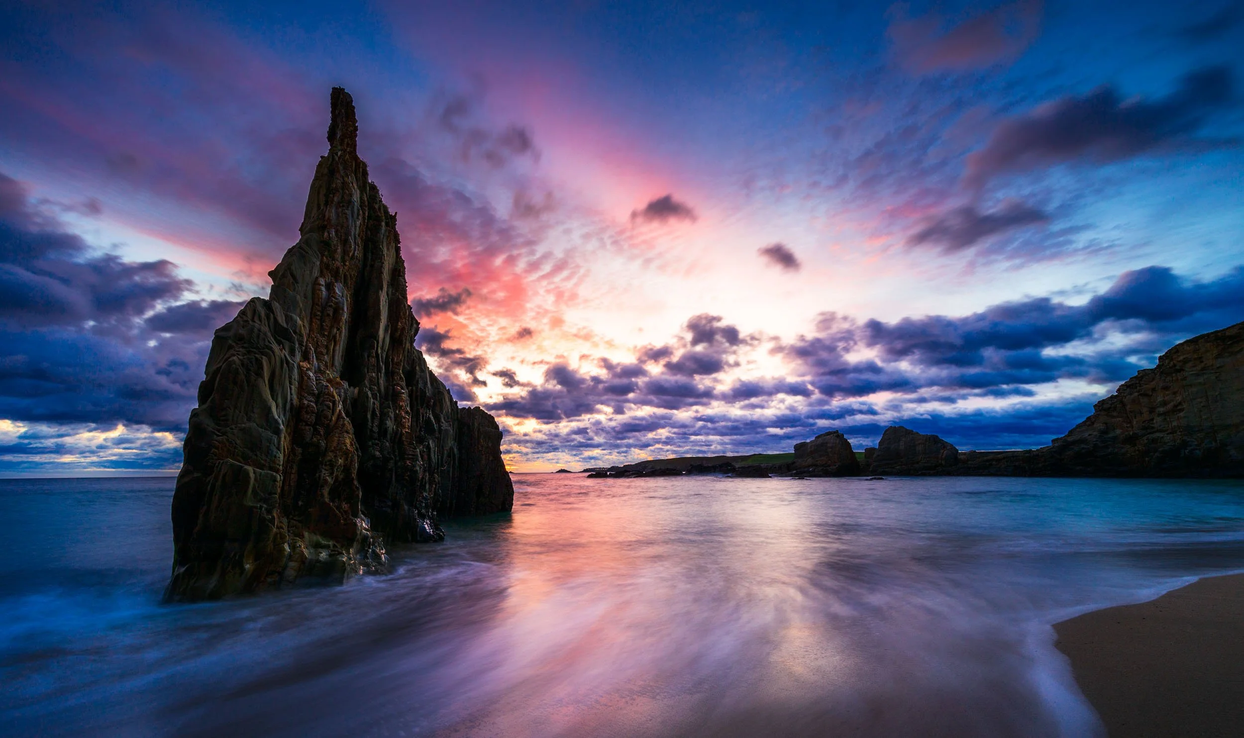 Sharp, pointed rock formation at the playa de mexota in the region of Asturias in northern Spain during sunrise. 